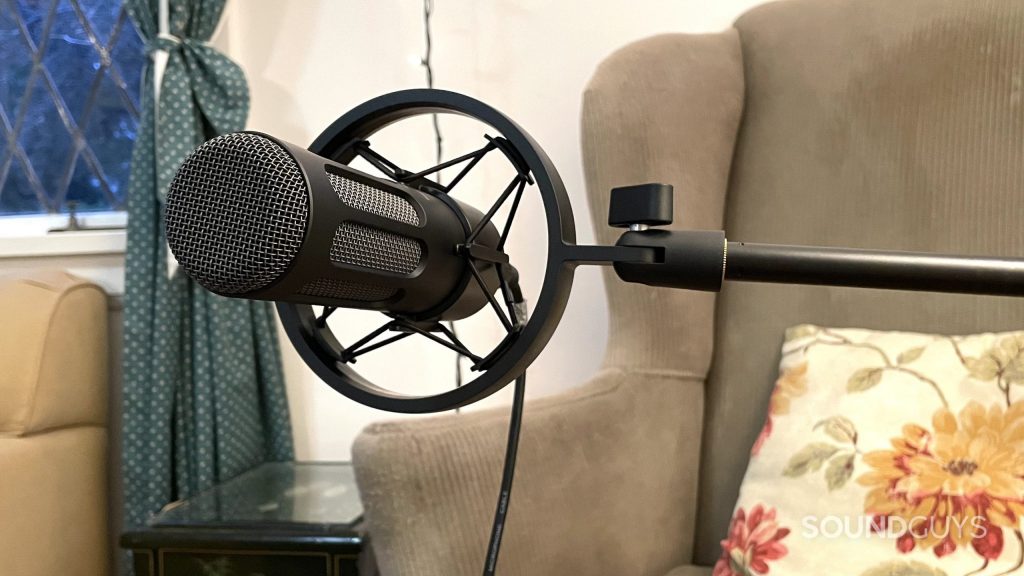 beyerdynamic M70 Pro X attached to a microphone stand with an armchair and curtain in the background.