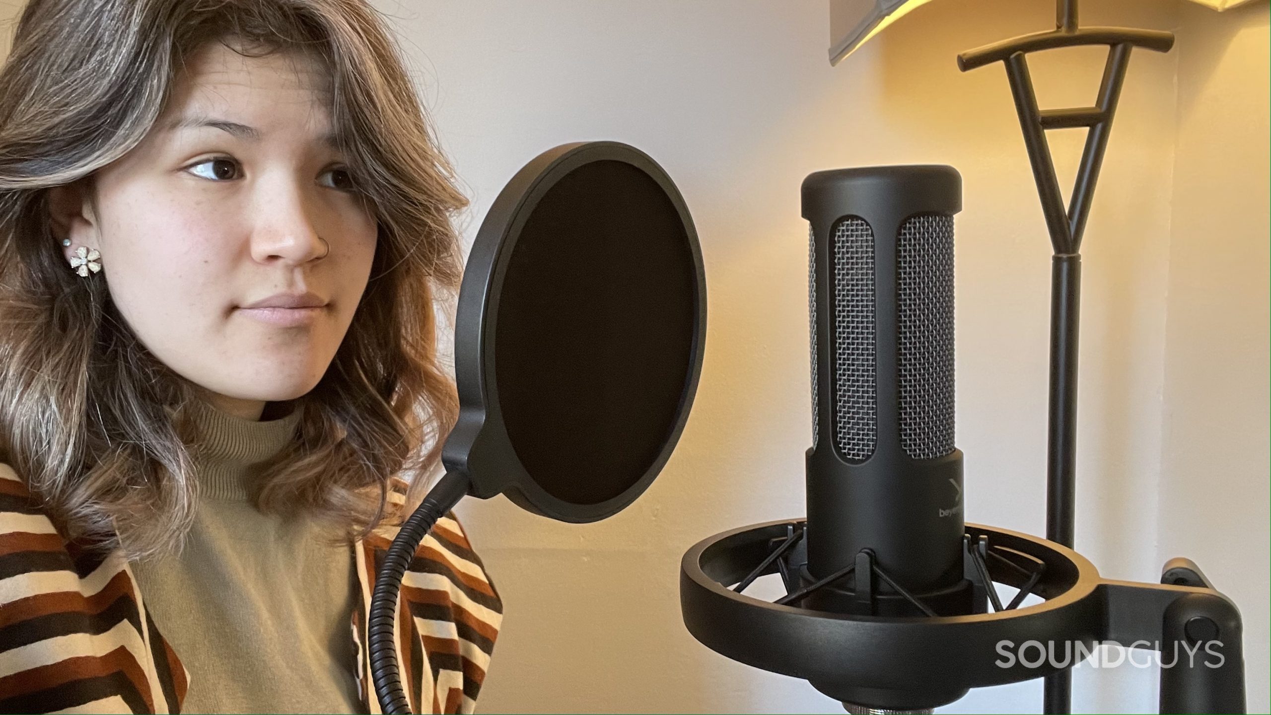 Woman using the Beyerdynamic M90 PRO X with its pop filter.