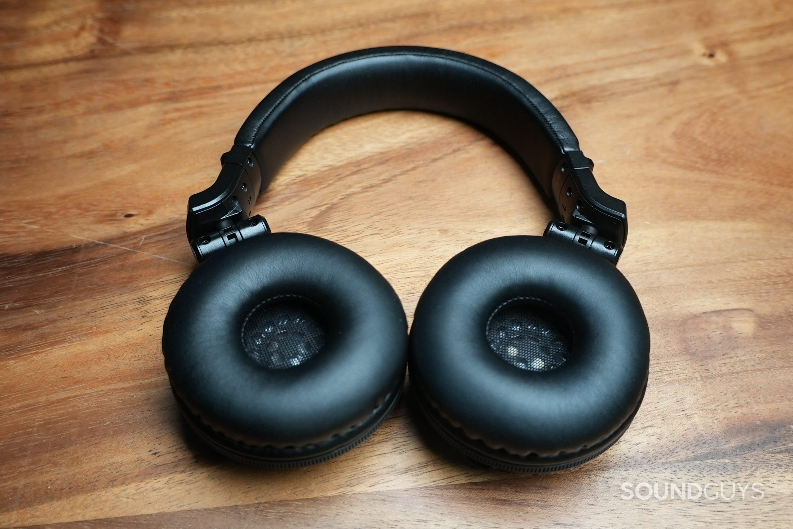 The Pioneer HDJ-CUE1BT lying on table with the inside of its ear cups facing up.