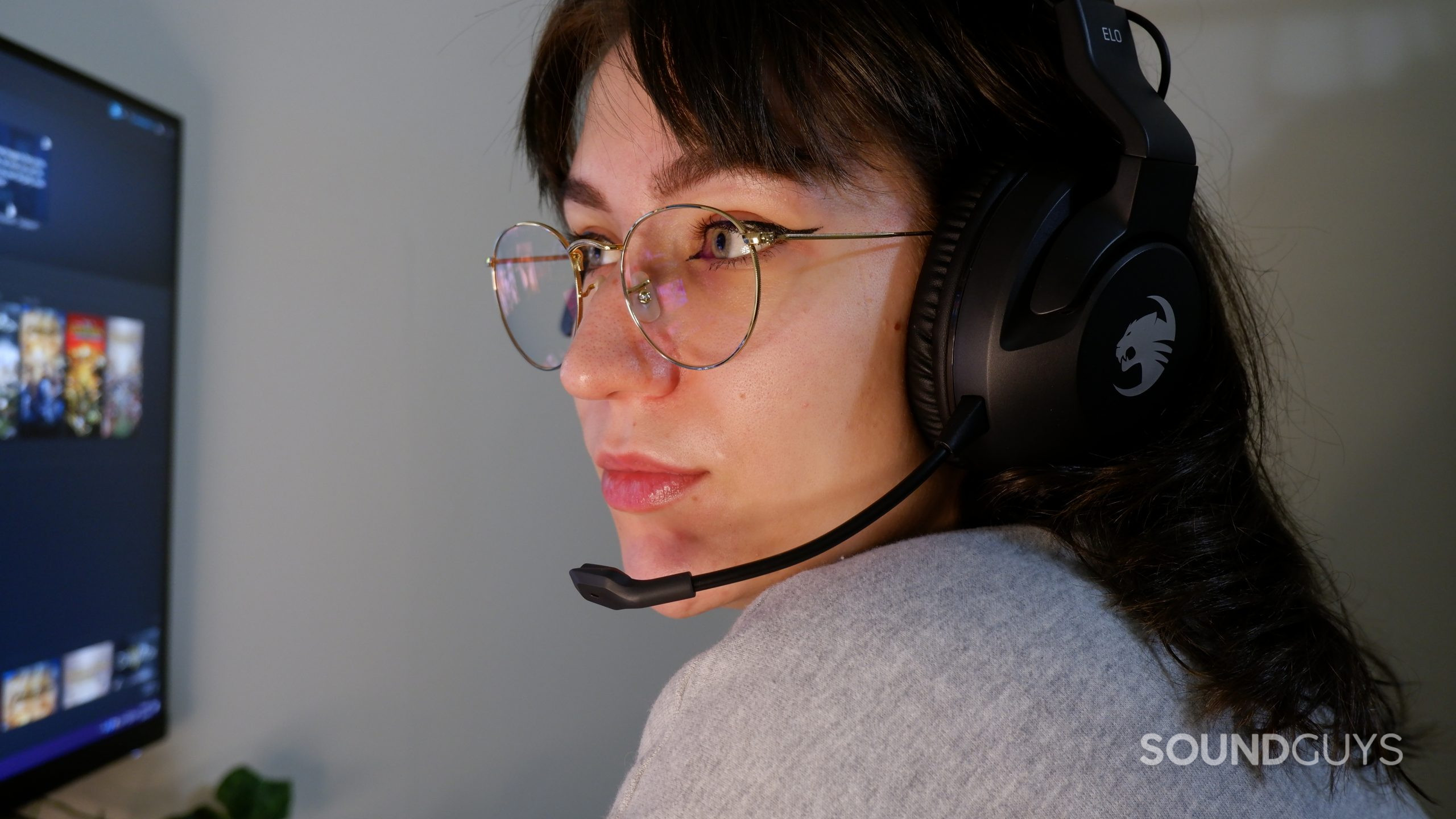 The ROCCAT Elo X Stereo headset on a person's head, while they look at a computer screen.