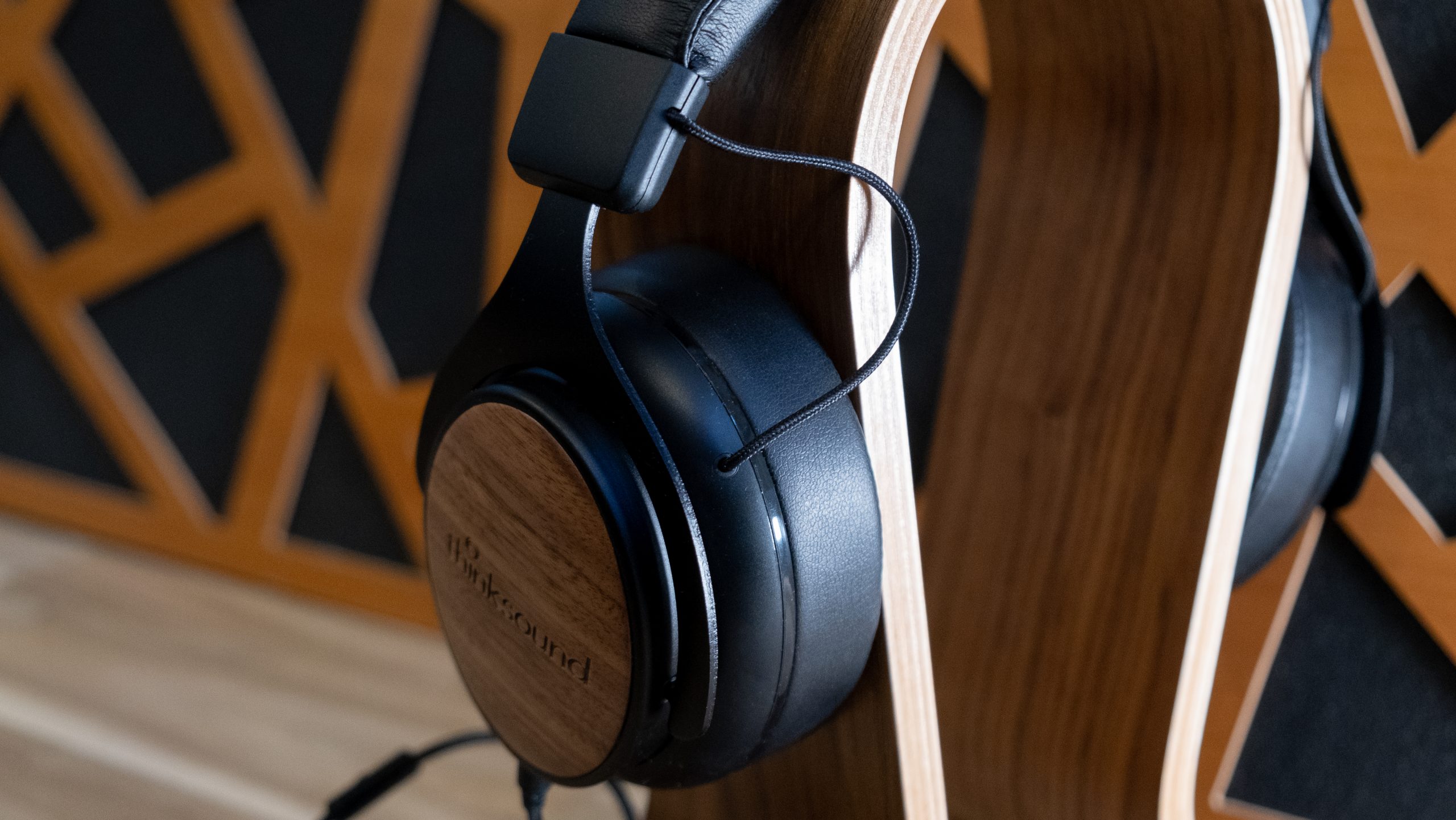 From behind the Thinksound ov21 has visible cabling on a headphone stand.
