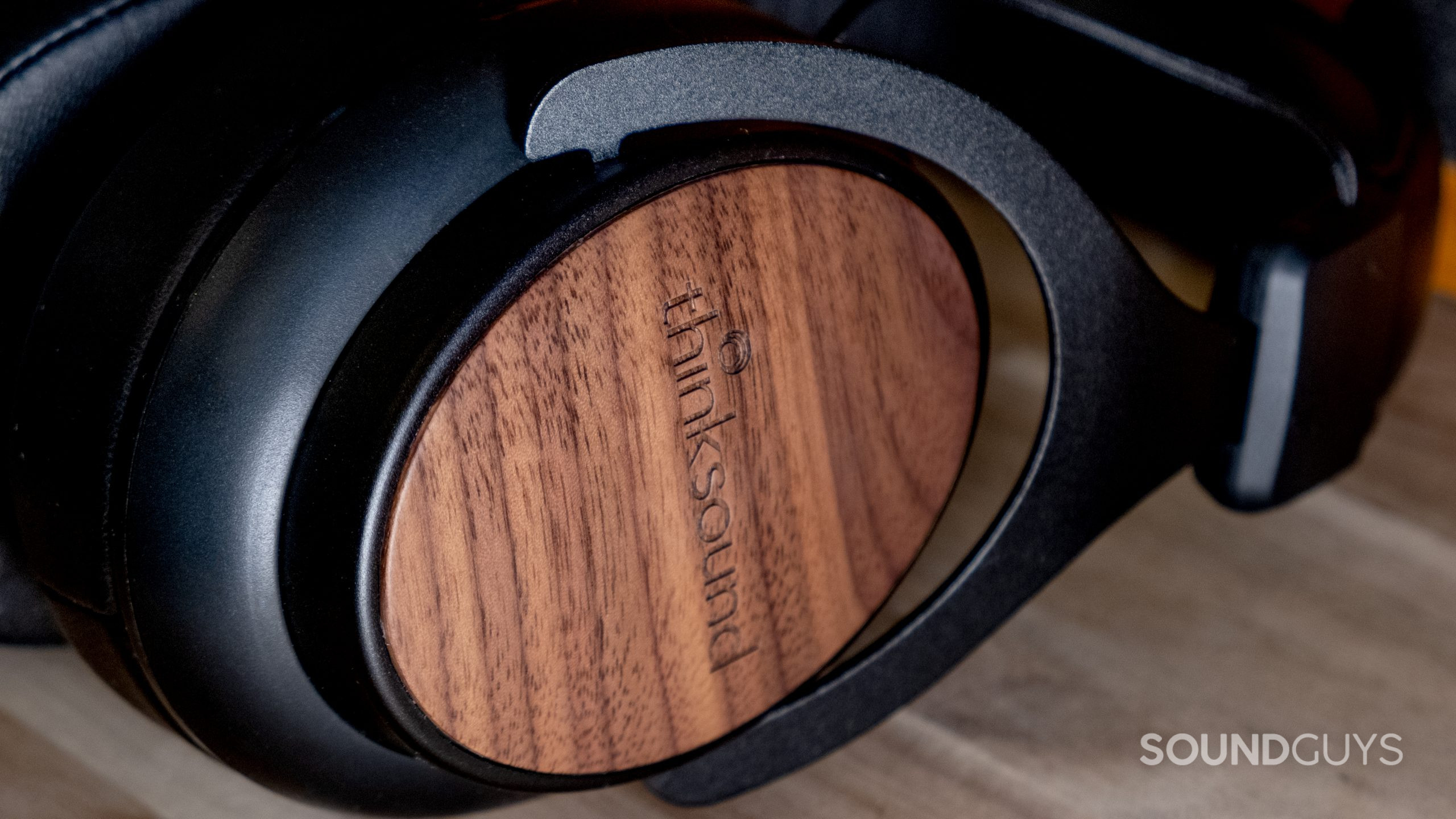 A close up of the Thinksound ov21 showcasing the wood ear cups.