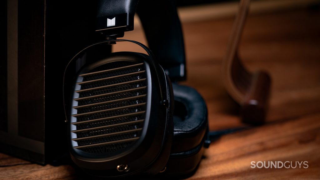 The Monoprice Monolith AMT sitting on a walnut table.