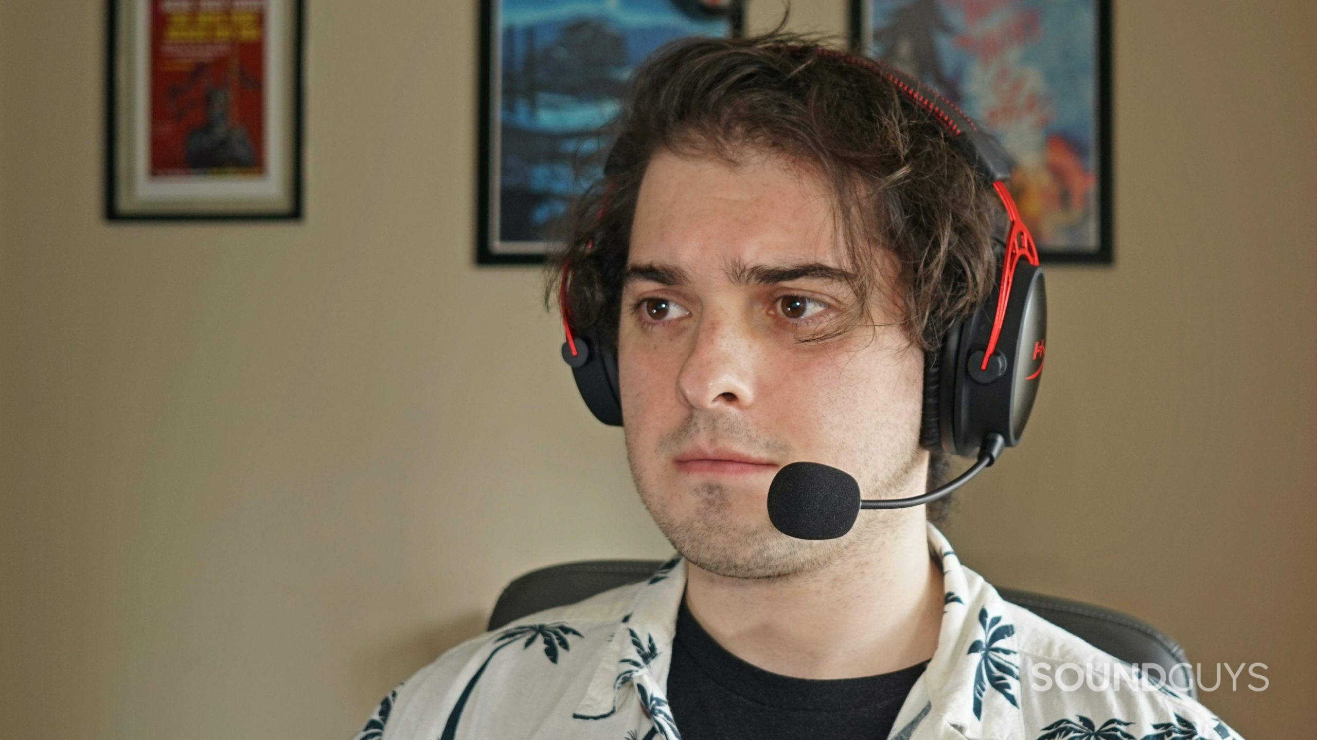 A man wears the HyperX Cloud Alpha Wireless gaming headset sitting at a computer.