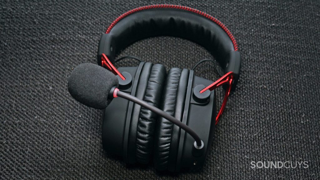 The HyperX Cloud Alpha Wireless gaming headset lays on a fabric surface
