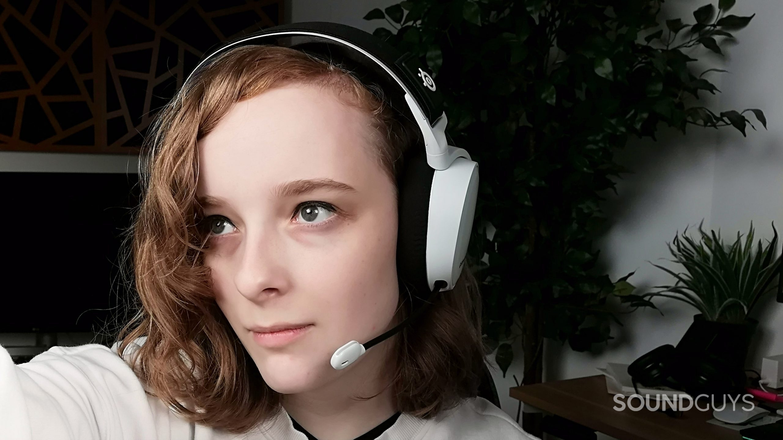 A person wears the SteelSeries Arctis 7P+ Wireless gaming headset.