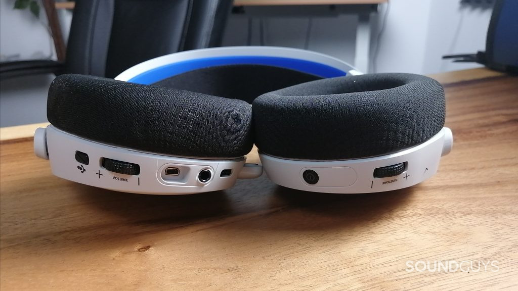 The SteelSeries Arctis 7P+ Wireless showing its controls while laying flat on a table.