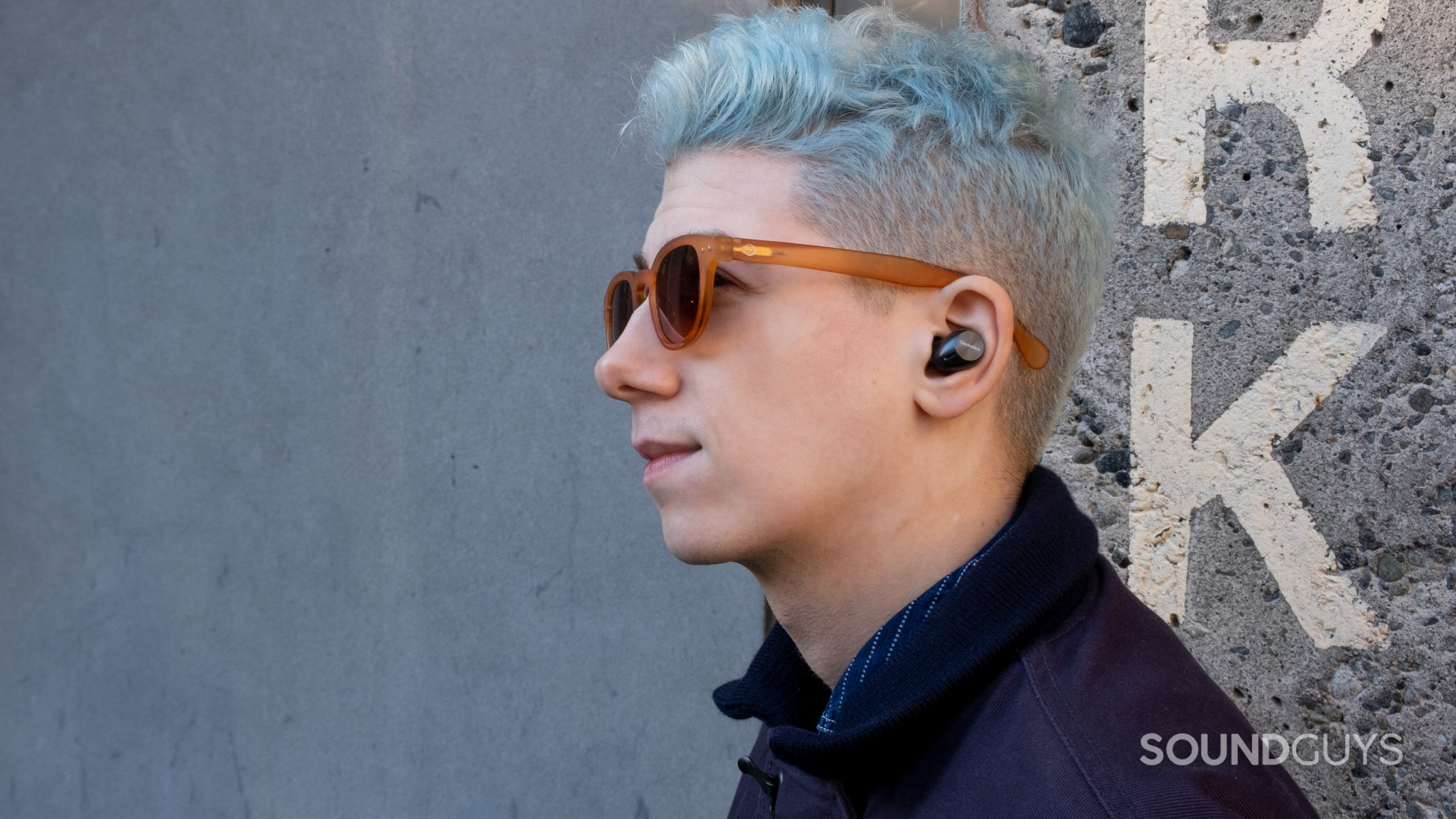 A man looks to the left wearing the Technics EAH-AZ40 in ears.