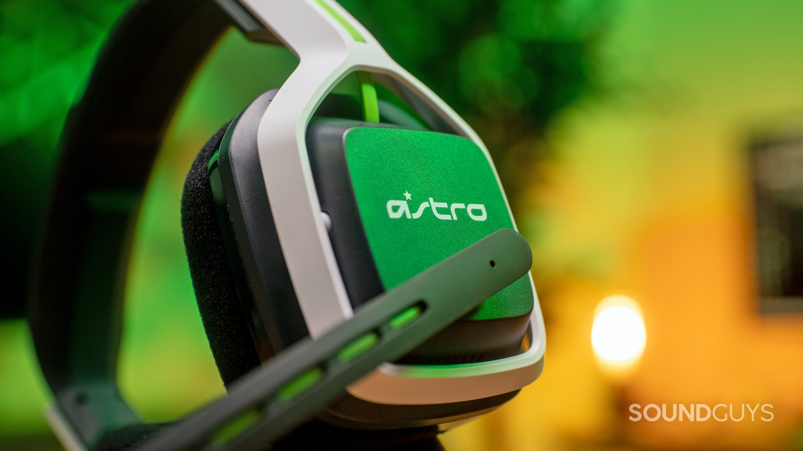The Astro A20 gaming headset lays on its side, showing its side panel and microphone.