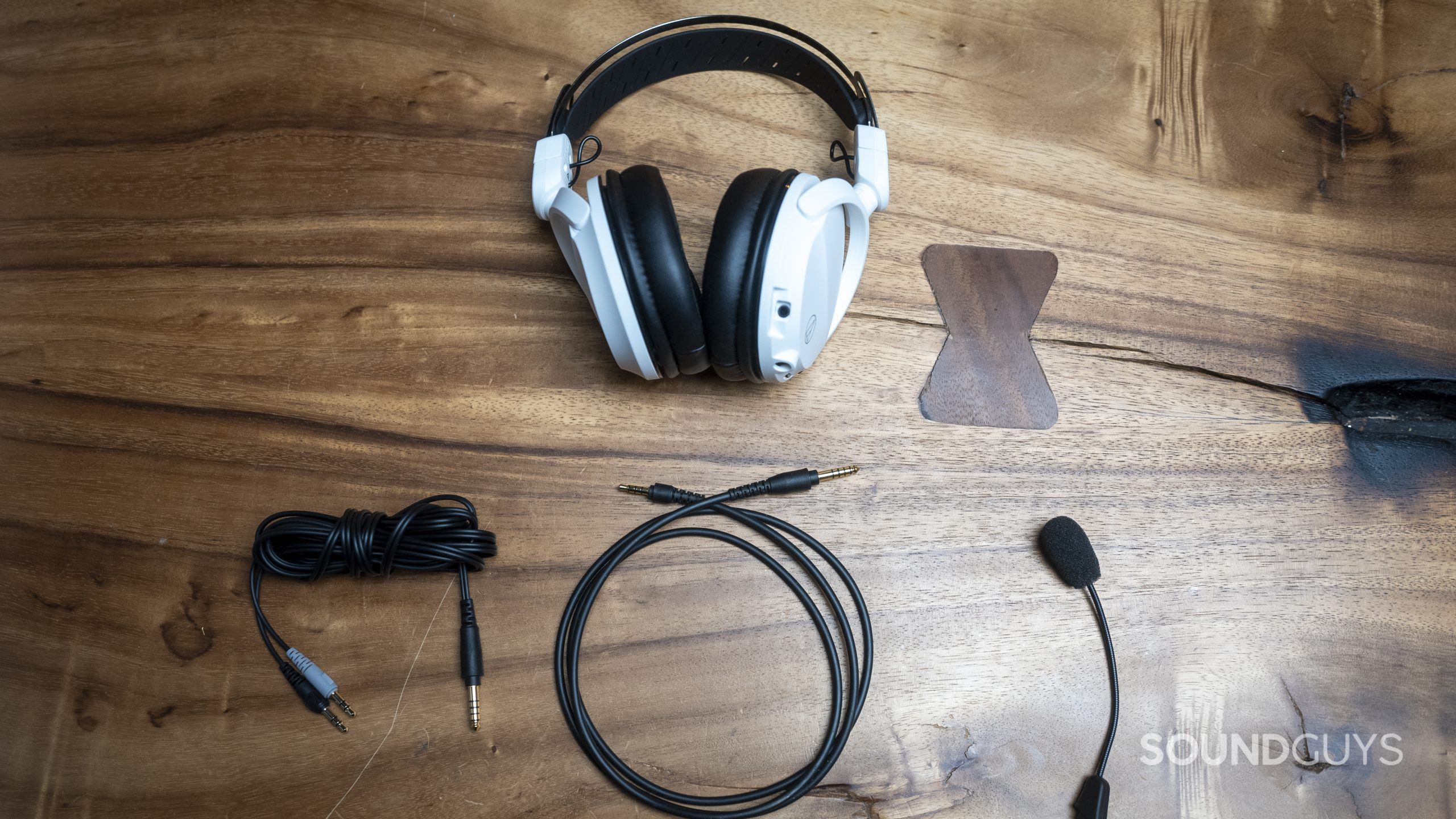 The Audio-Technica ATH-GL3 gaming headset accessories flat against a wood table.