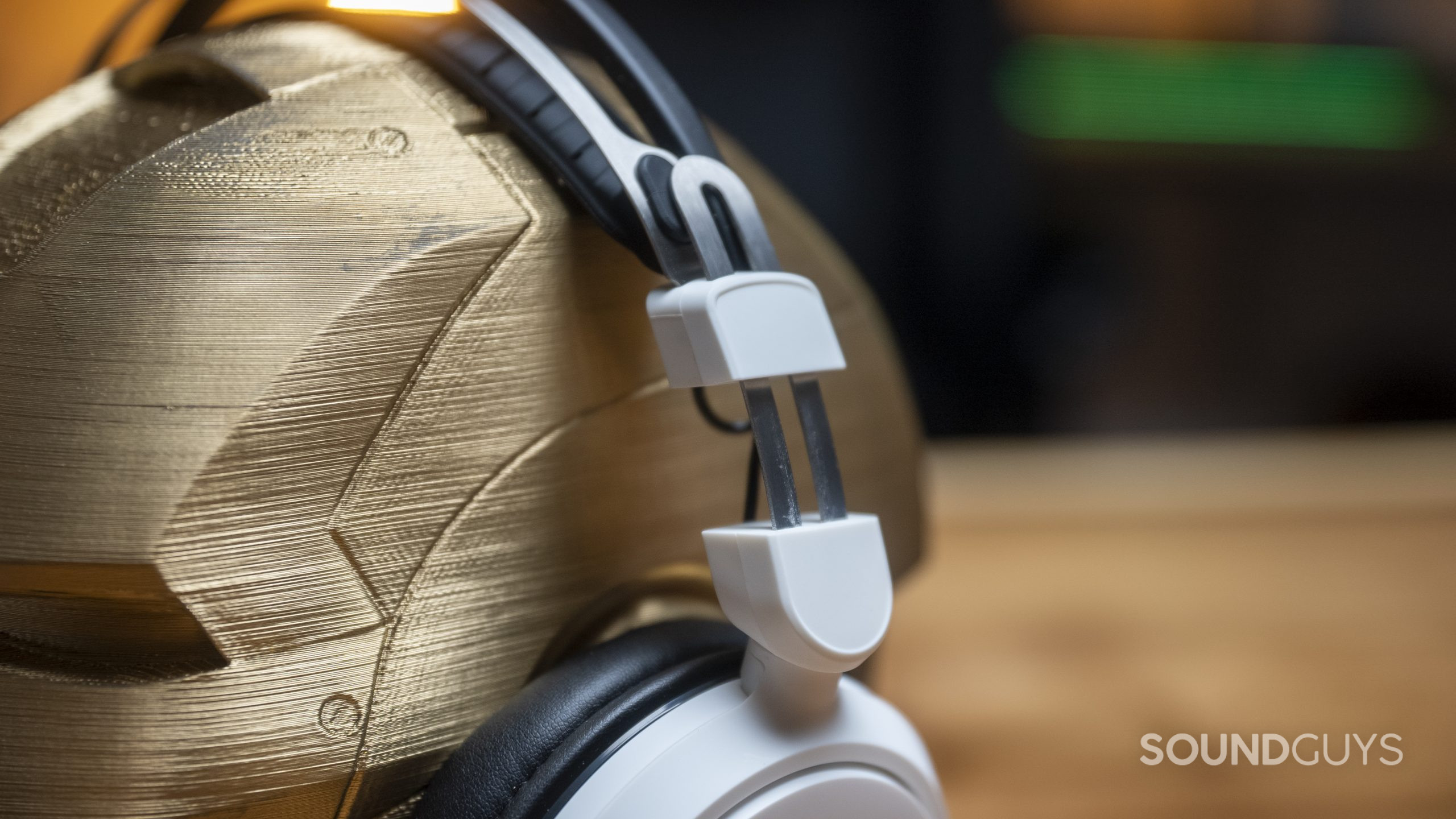 The Audio-Technica ATH-GL3 gaming headset's expanded headband as it rests on a wooden head.