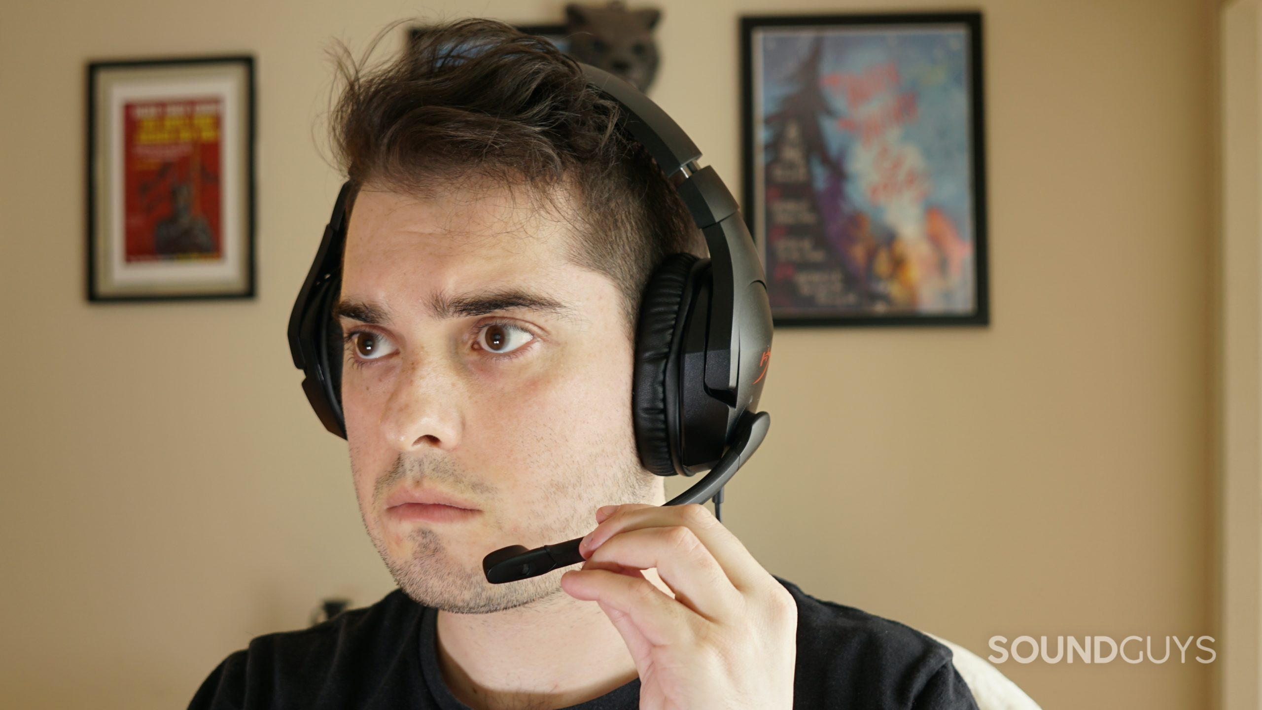 A man sits at a computer wearing the HyperX Cloud Stinger gaming headset.