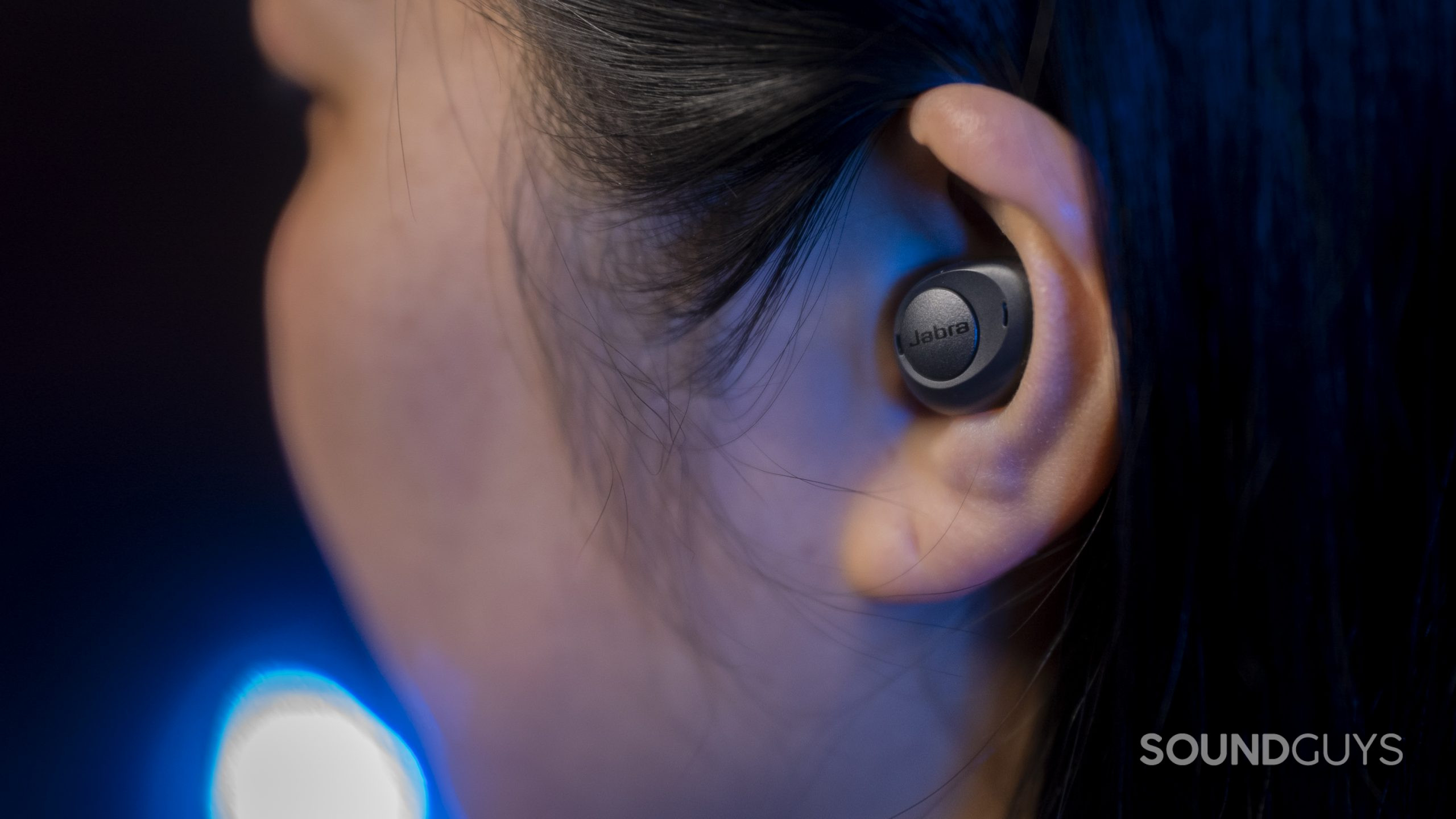 The Jabra Enhance Plus hearing aid hearable in a woman's left ear.