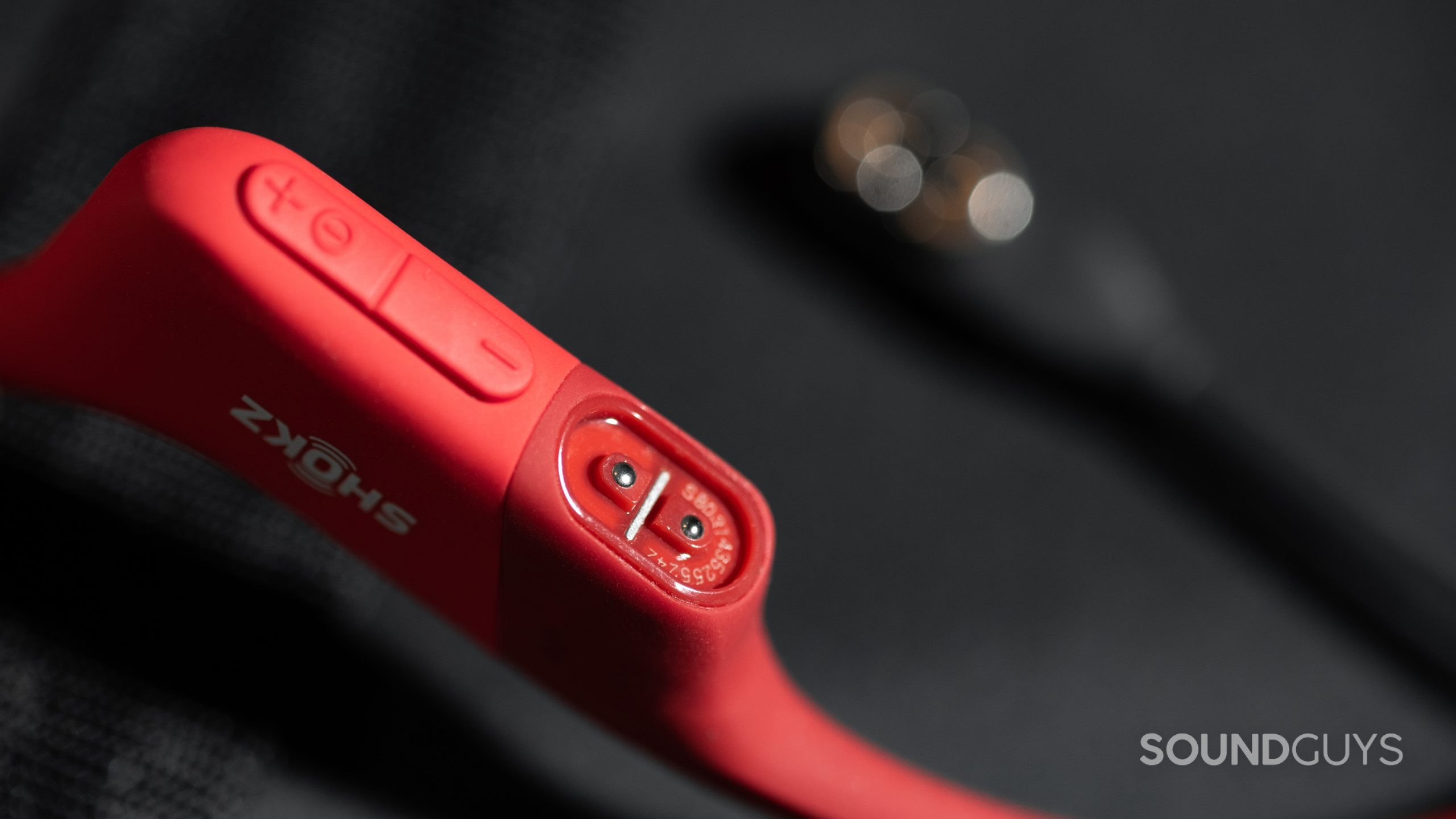 The proprietary two-pin connector on the Shokz OpenRun bone conduction headphones.