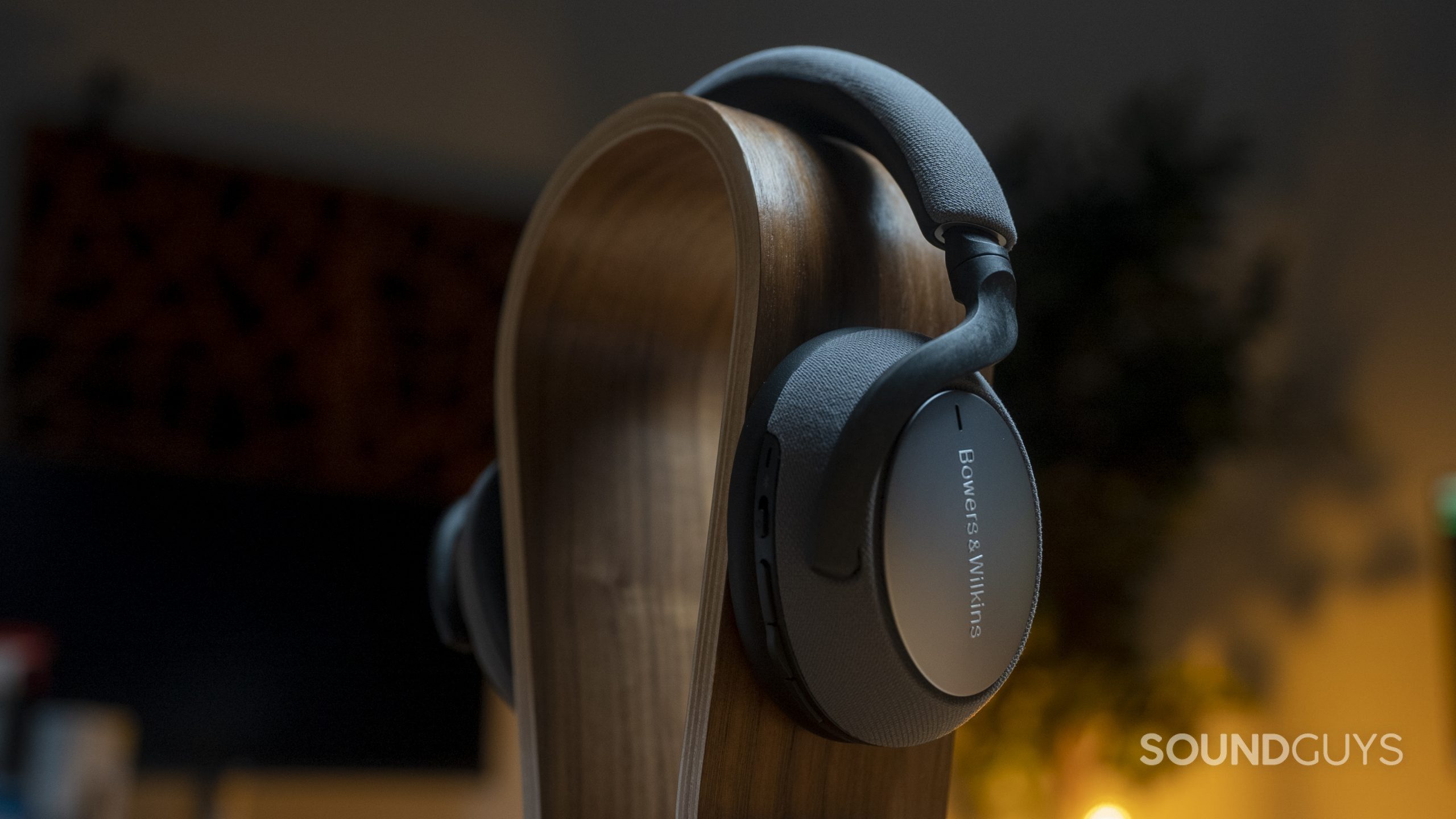 The Bowers &amp; Wilkins PX7 sitting on an omega-shaped headphone stand.
