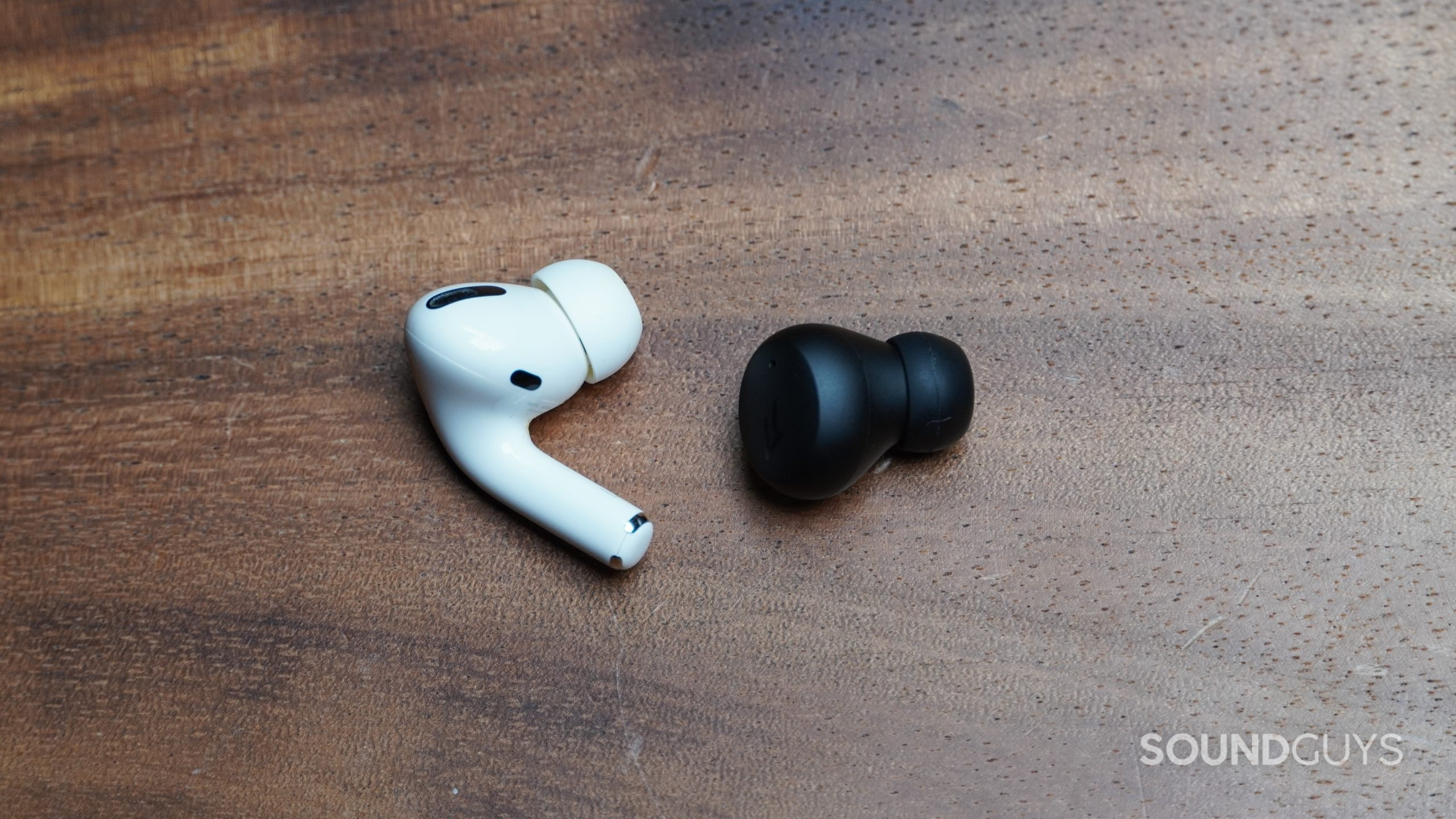 1MORE ComfoBuds Mini next to Apple AirPods Pro earbud