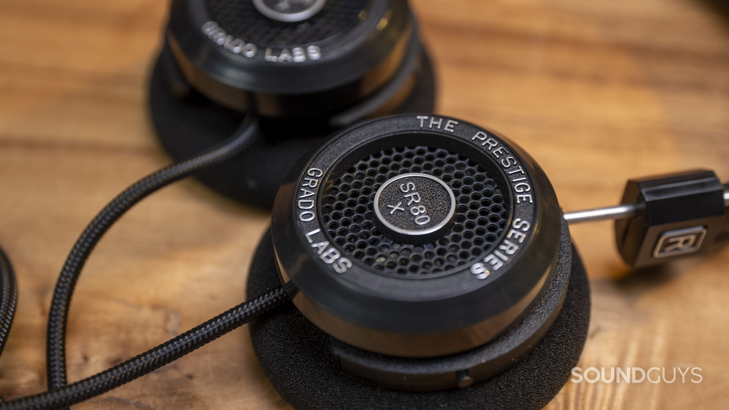 A close up of the Grado Labs SR80x right ear cup on a wood surface.