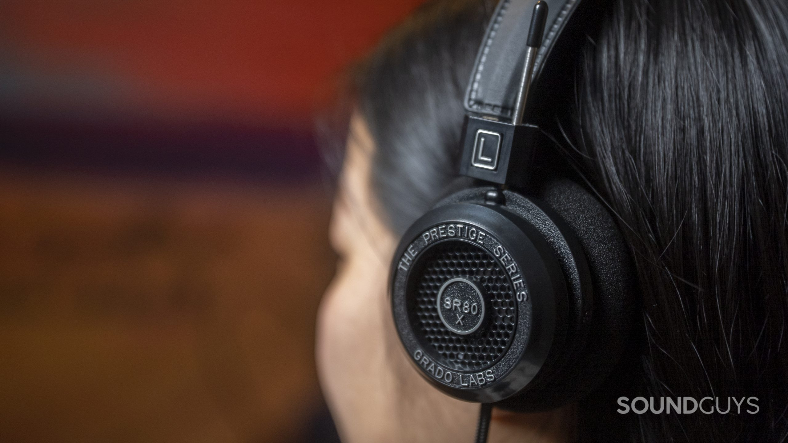 A woman photographed from behind and to the side wears the Grado Labs SR80x.