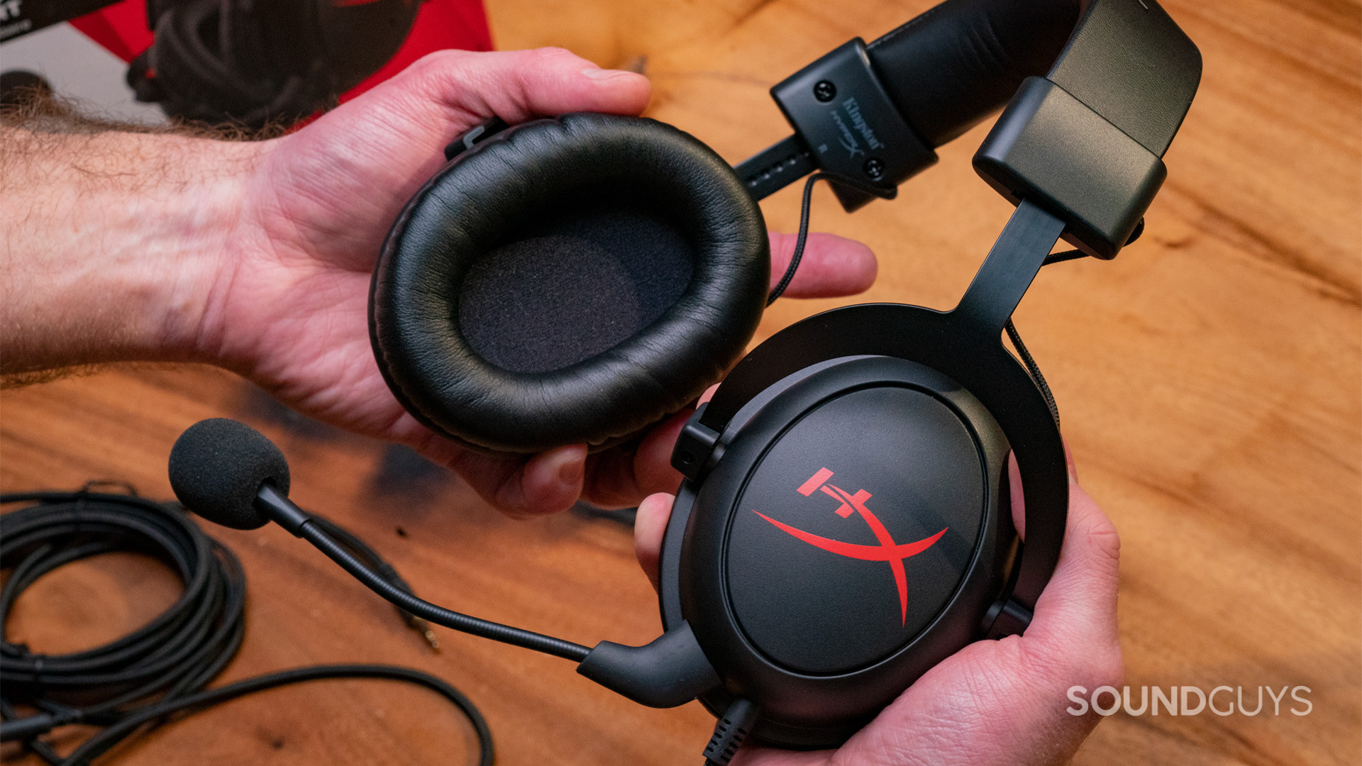 The HyperX Cloud Core being held in two hands and showing the ear cups
