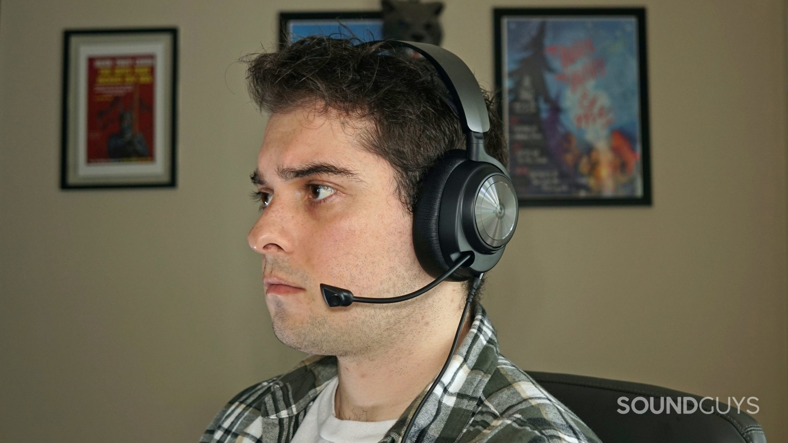 A man sits at a computer wearing the SteelSeries Arctis Nova Pro.