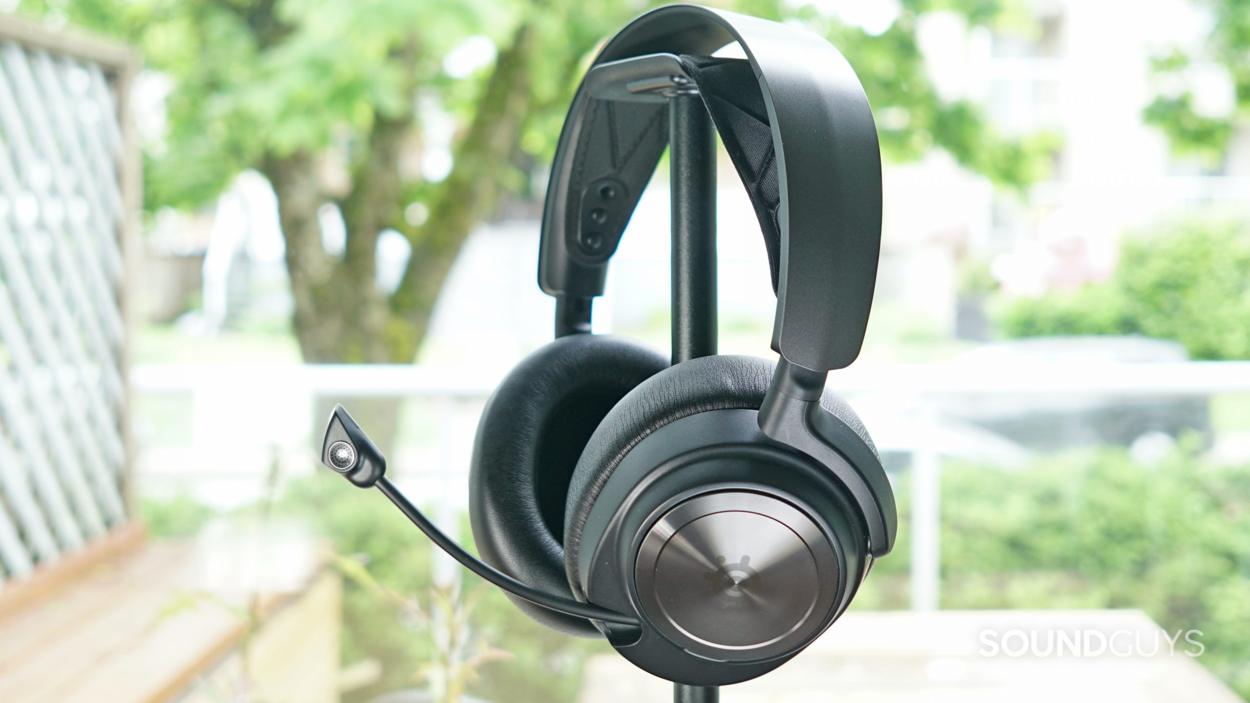 The SteelSeries Arctis Nova Pro sits on a headphone stand
