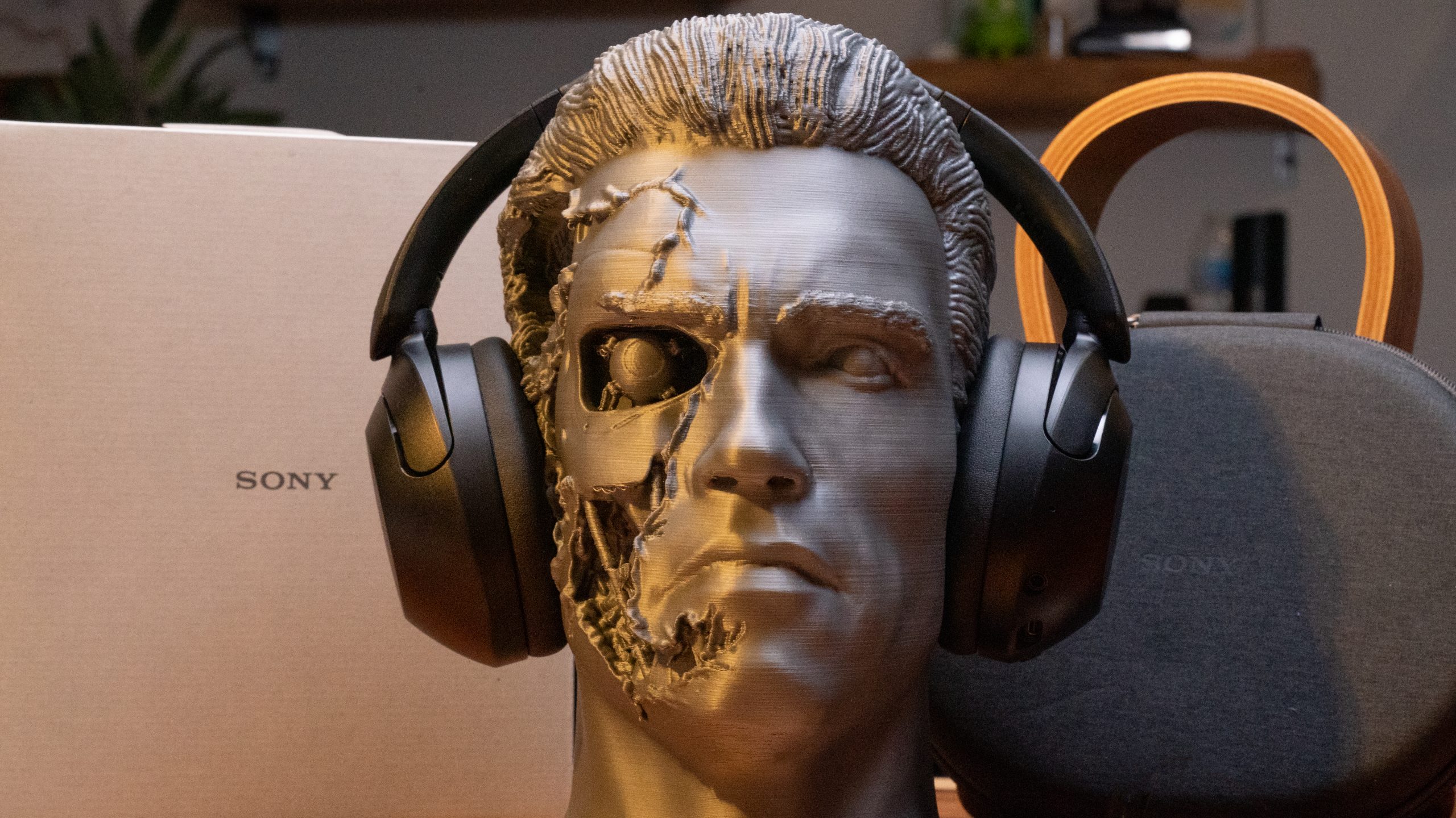 A bust of The Terminator faces the camera head on wearing the Sony WH-XB910N.