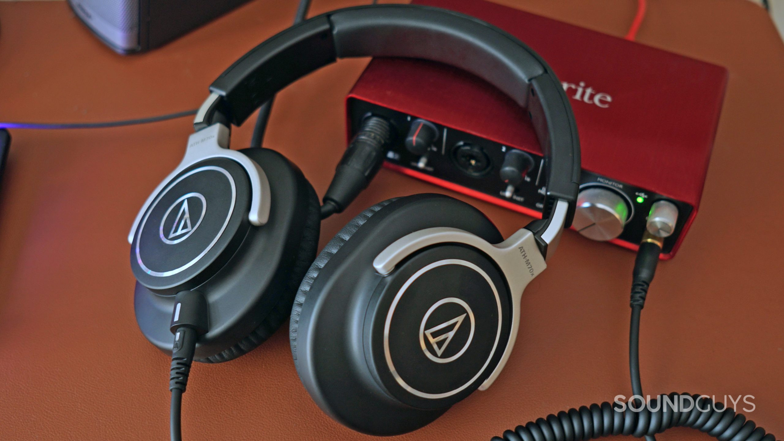 The Audio-Technica ATH-M70x lays on a Focusrite Scarlett 2i2 which it's plugged into.