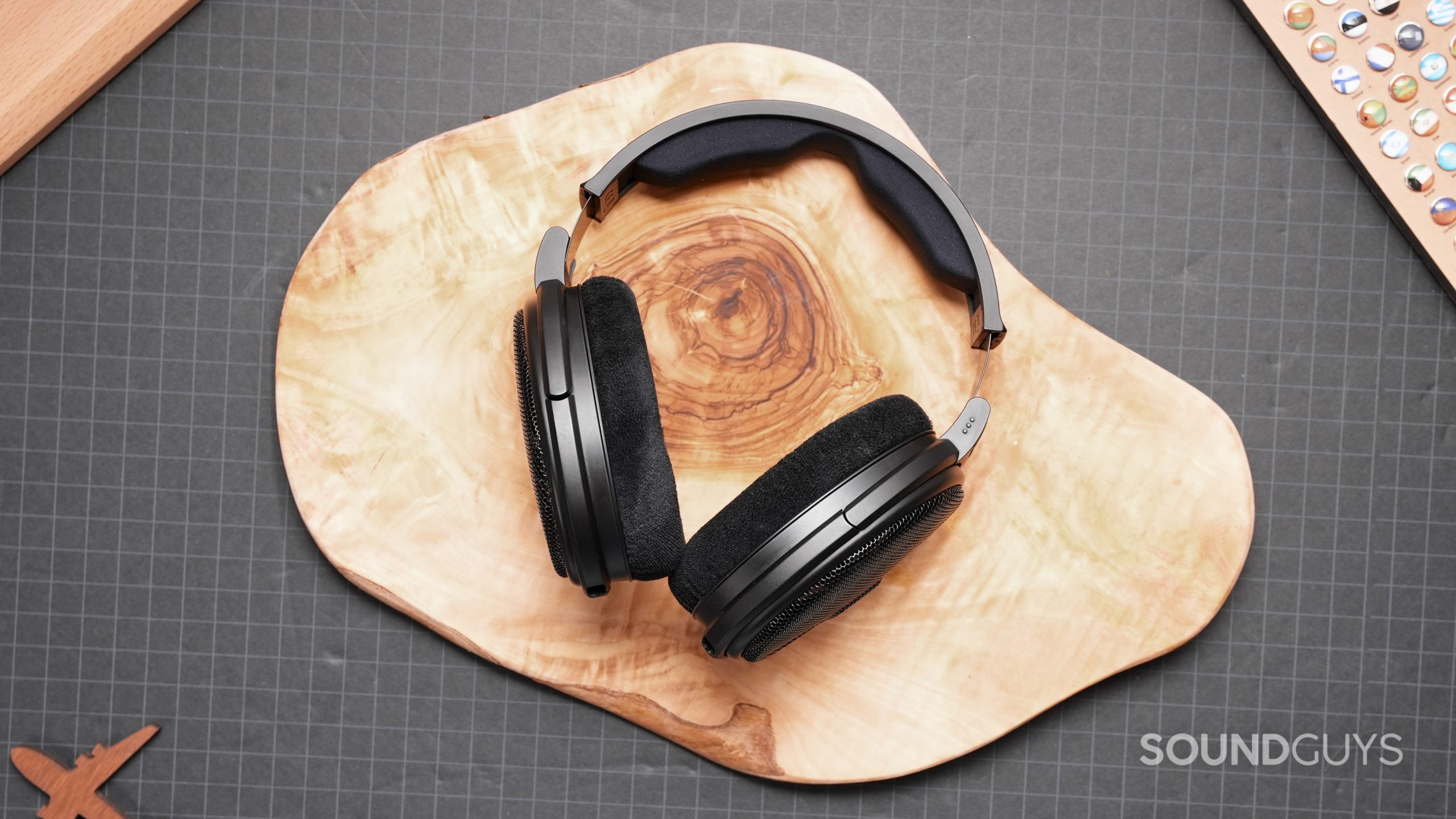 The Sennheiser HD660S shown resting on a wooden slab.