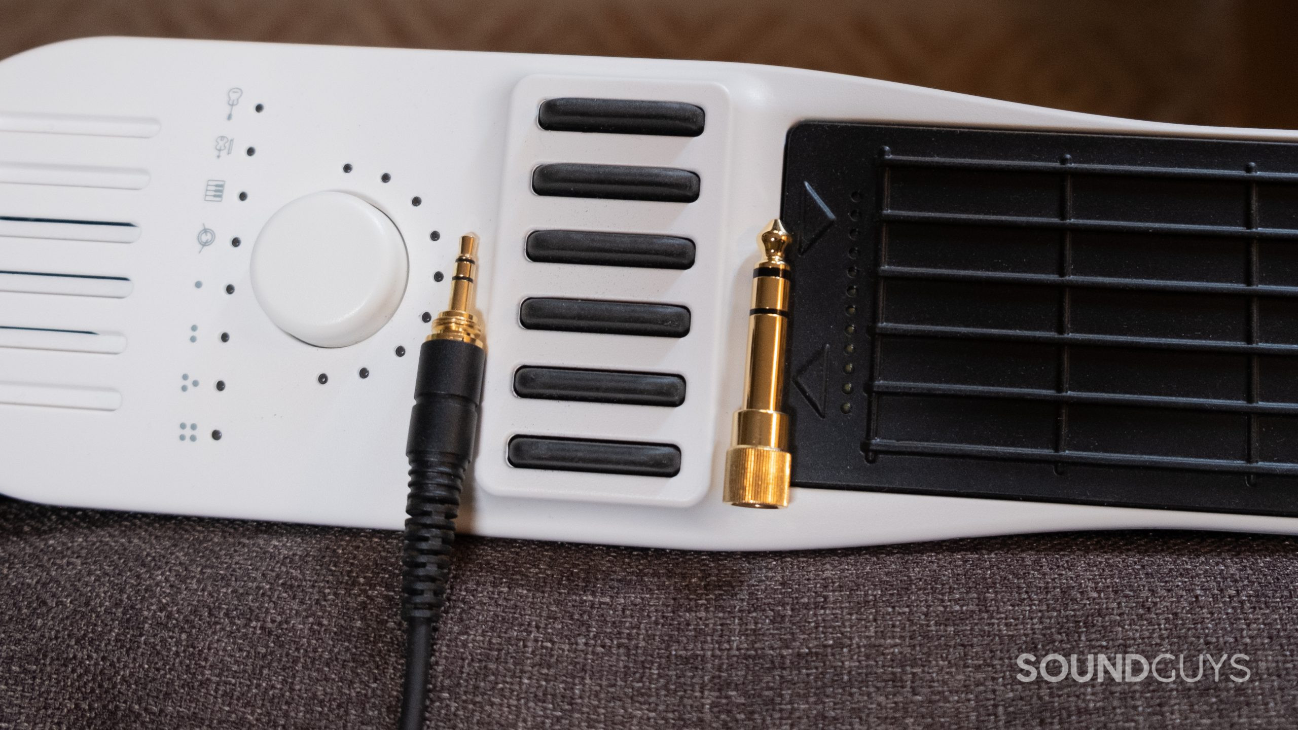 The 3.5mm headphone jack with the 1/4-inch adapter included with the AKG K702 shown resting on a midi controller.