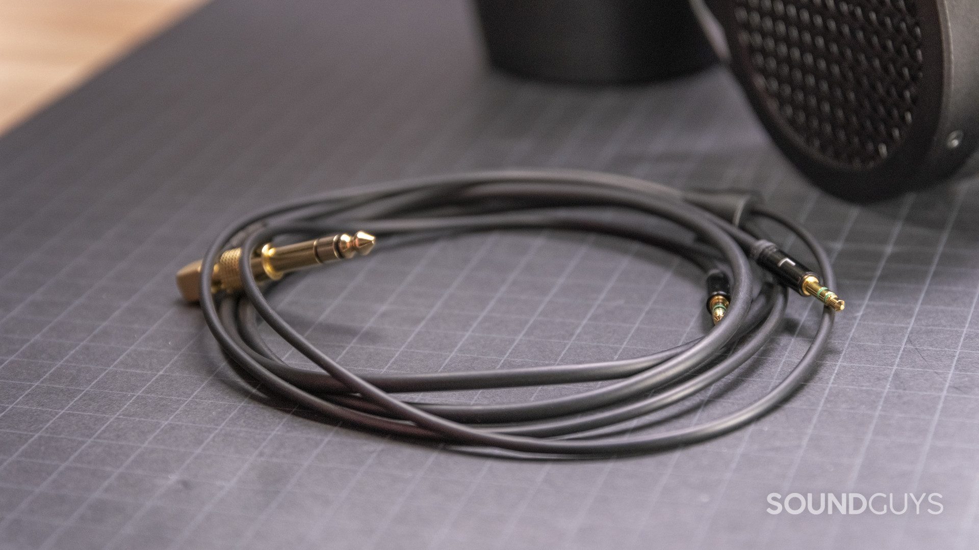 The cable that comes with the HiFiMan Sundara rests on a gridded surface.