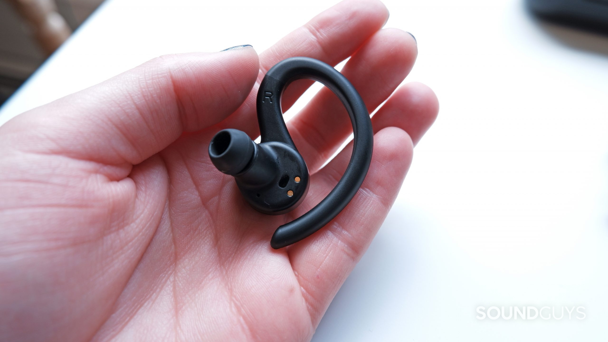 The JLab Epic Air Sport ANC in a hand, showing the inside of the earbud.