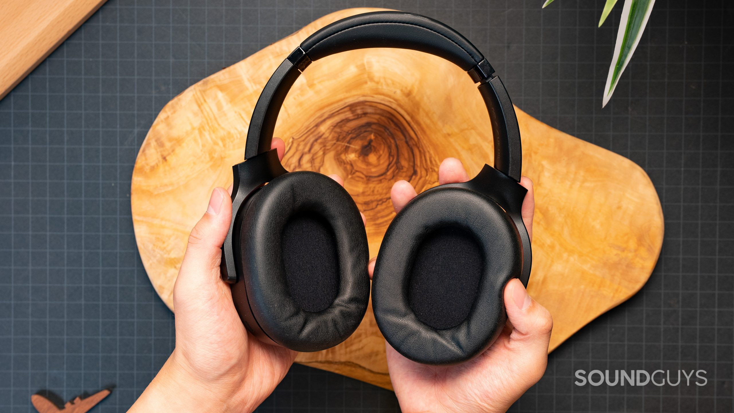 The inside surface of the ear cups on the Razer Barracuda Pro being held in someone's hands.