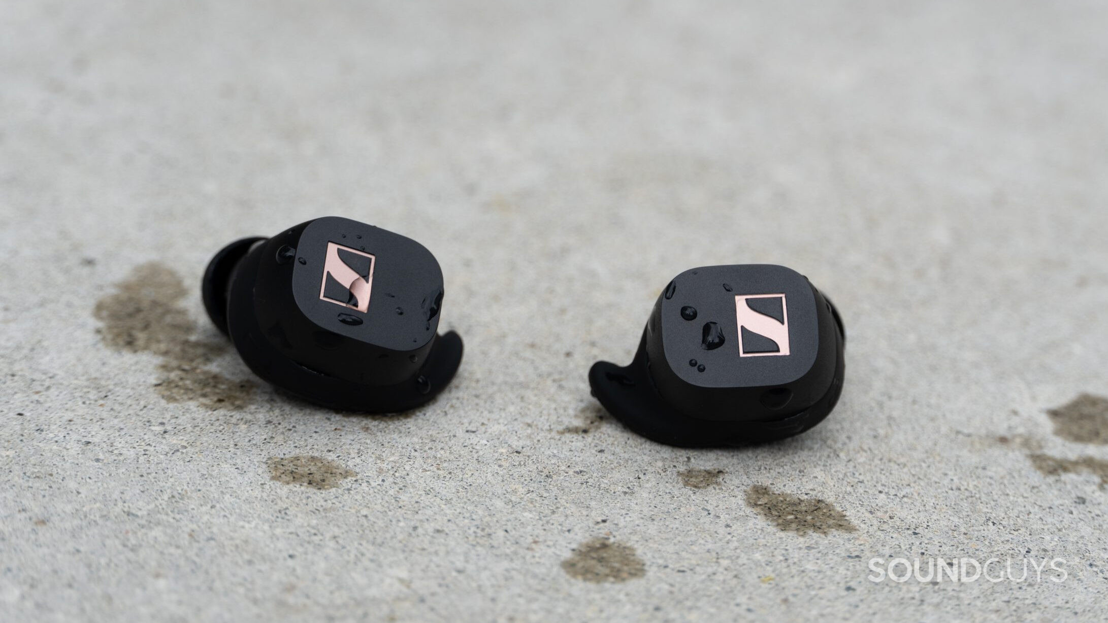 Sennheiser Sport True Wireless earbuds outside covered in water droplets