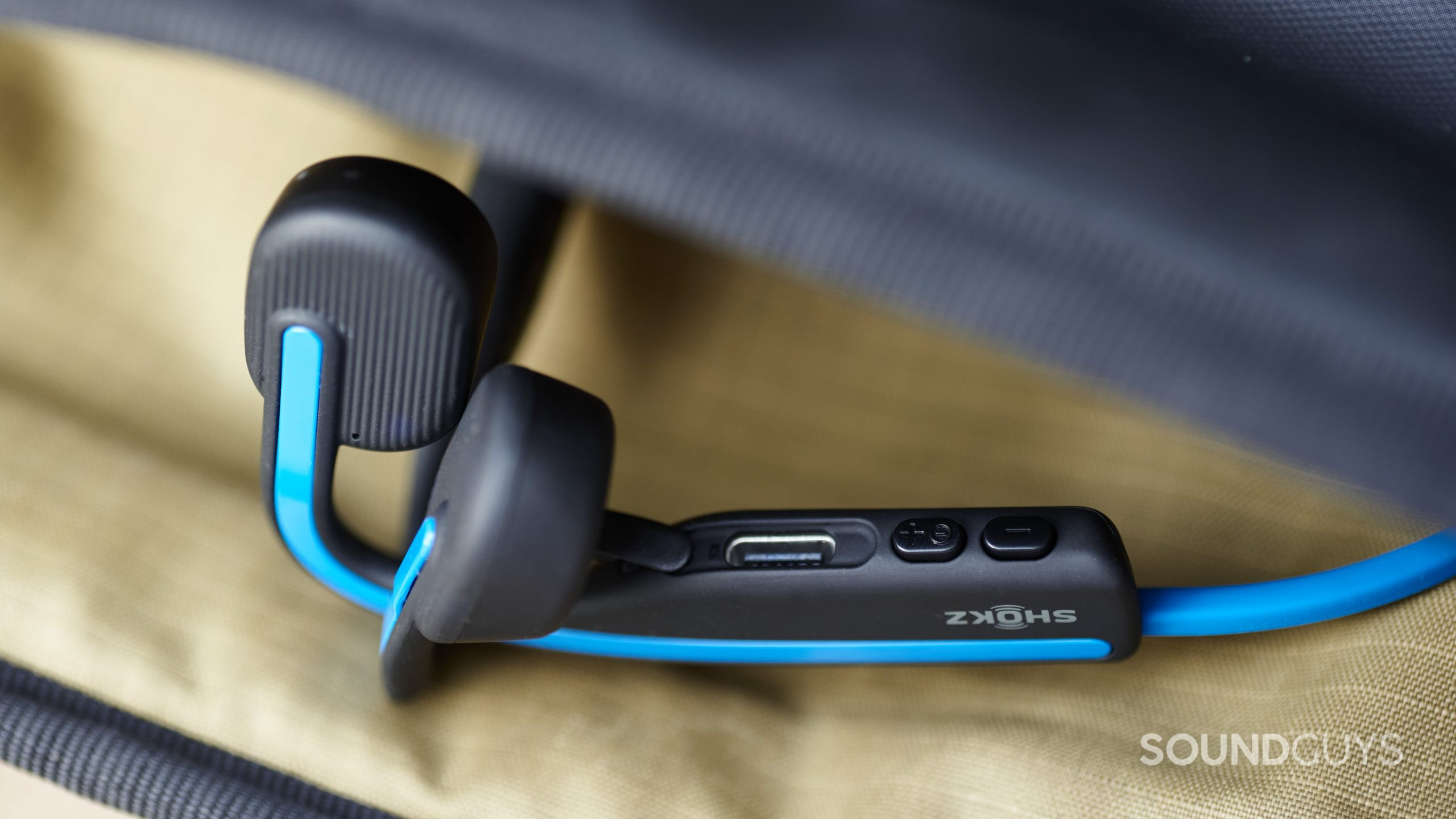 The Shokz OpenMove bone conduction headphones controls and USB-C charging input.