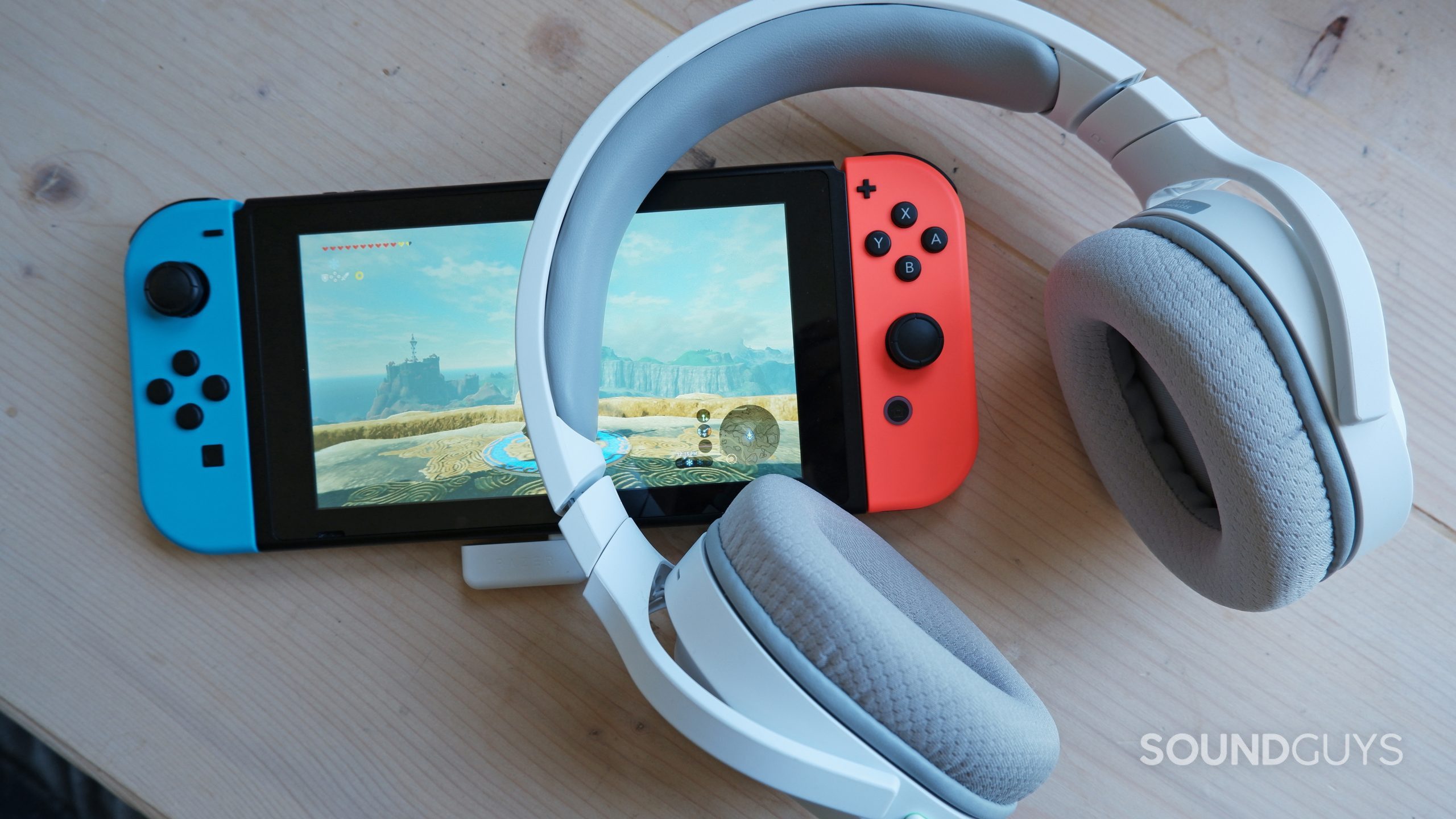 The Razer Barracuda X (2022) laying against a Nintendo Switch with The Legend of Zelda: Breath of the Wild on the screen.