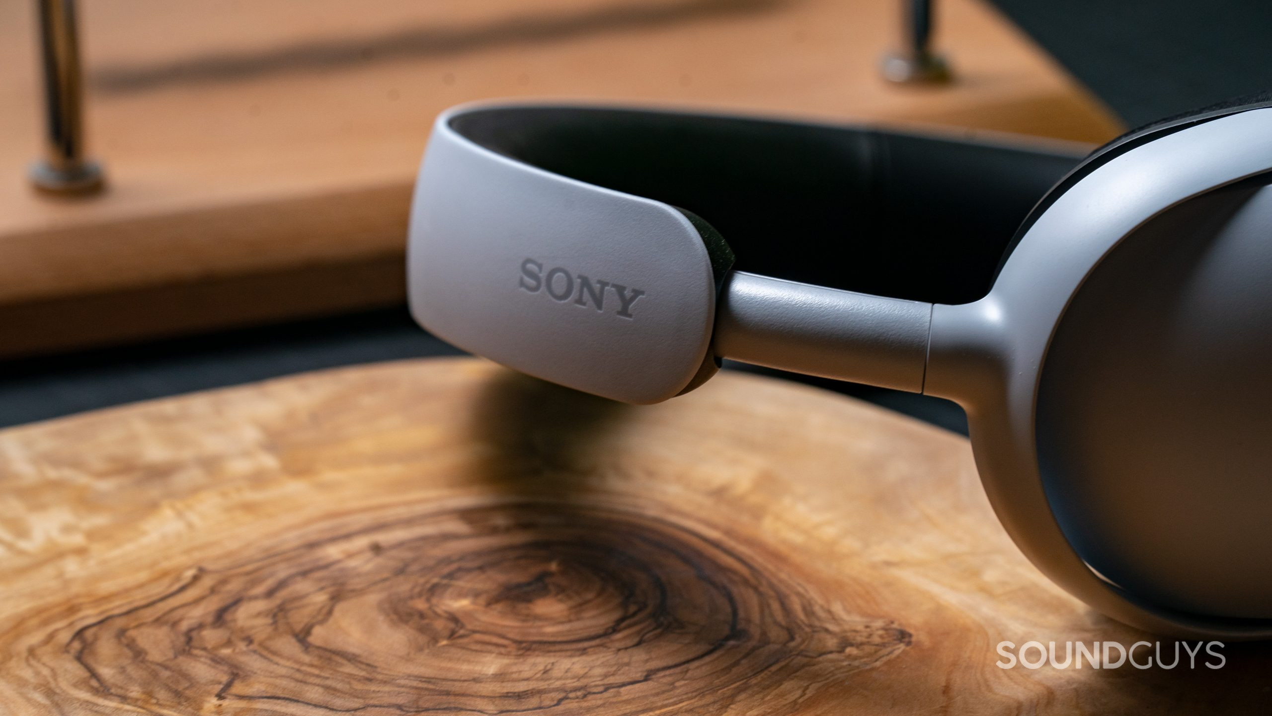 The Sony INZONE H3 sitting on a tabletop with a close up of the Sony logo on the headband.