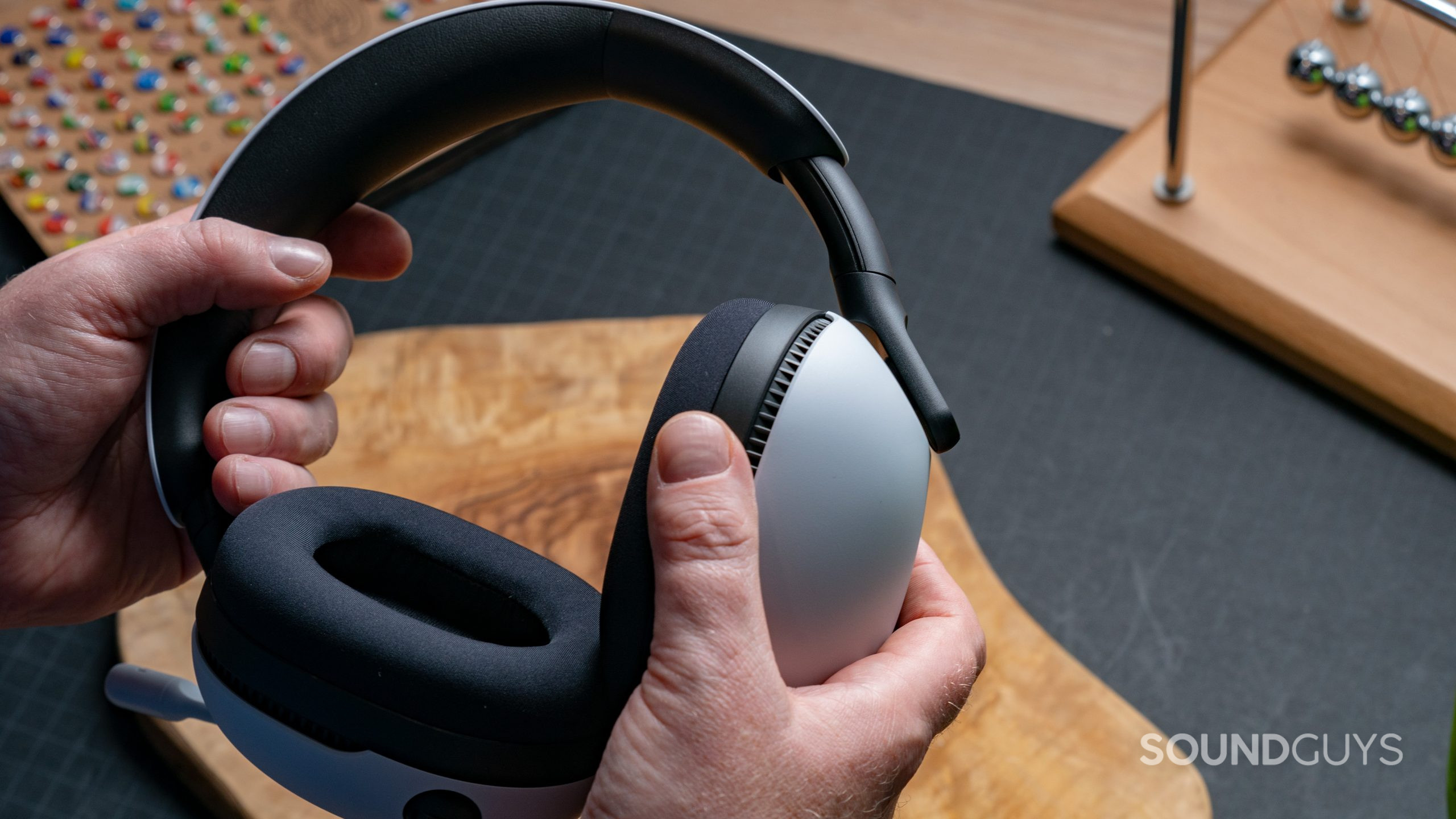The Sony INZONE H7 gaming headset is held in someone hands.