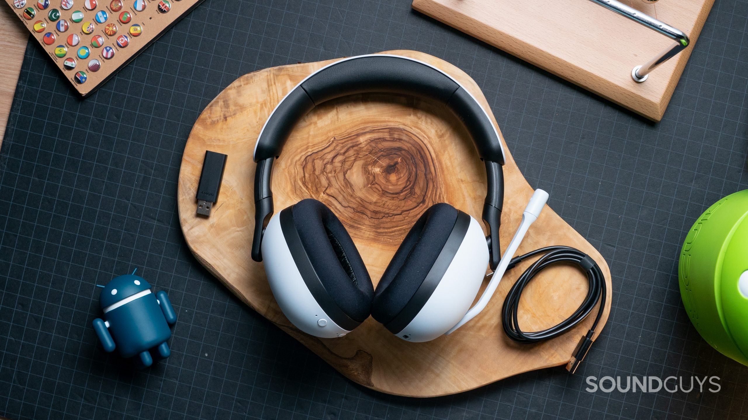 The Sony INZONE H7 gaming headset lays on a wooden surface