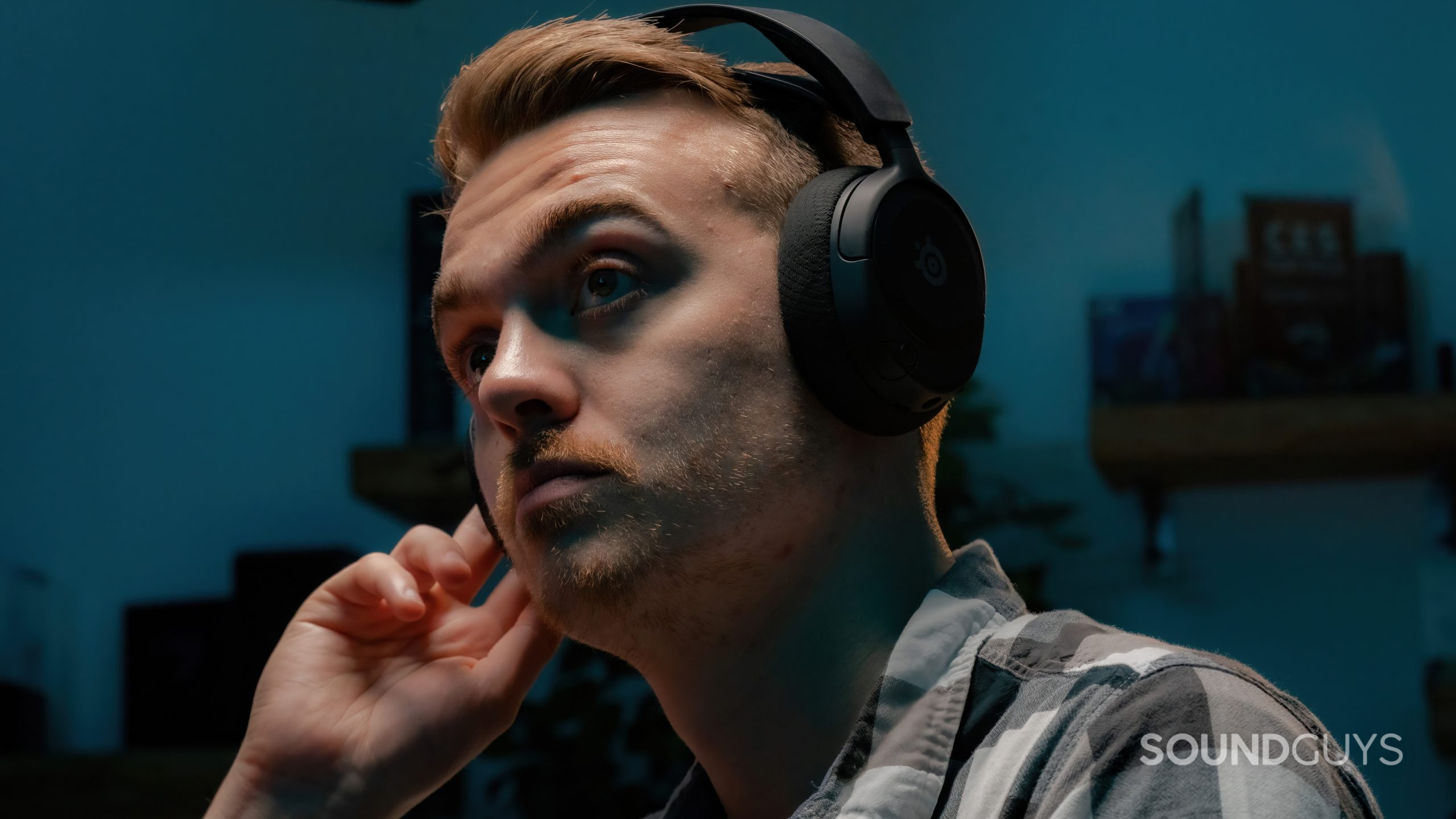 SteelSeries Arctis Nova 1 headshot The SteelSeries Arctis Nova 1 being worn by a user with their hand to one of the earcups.