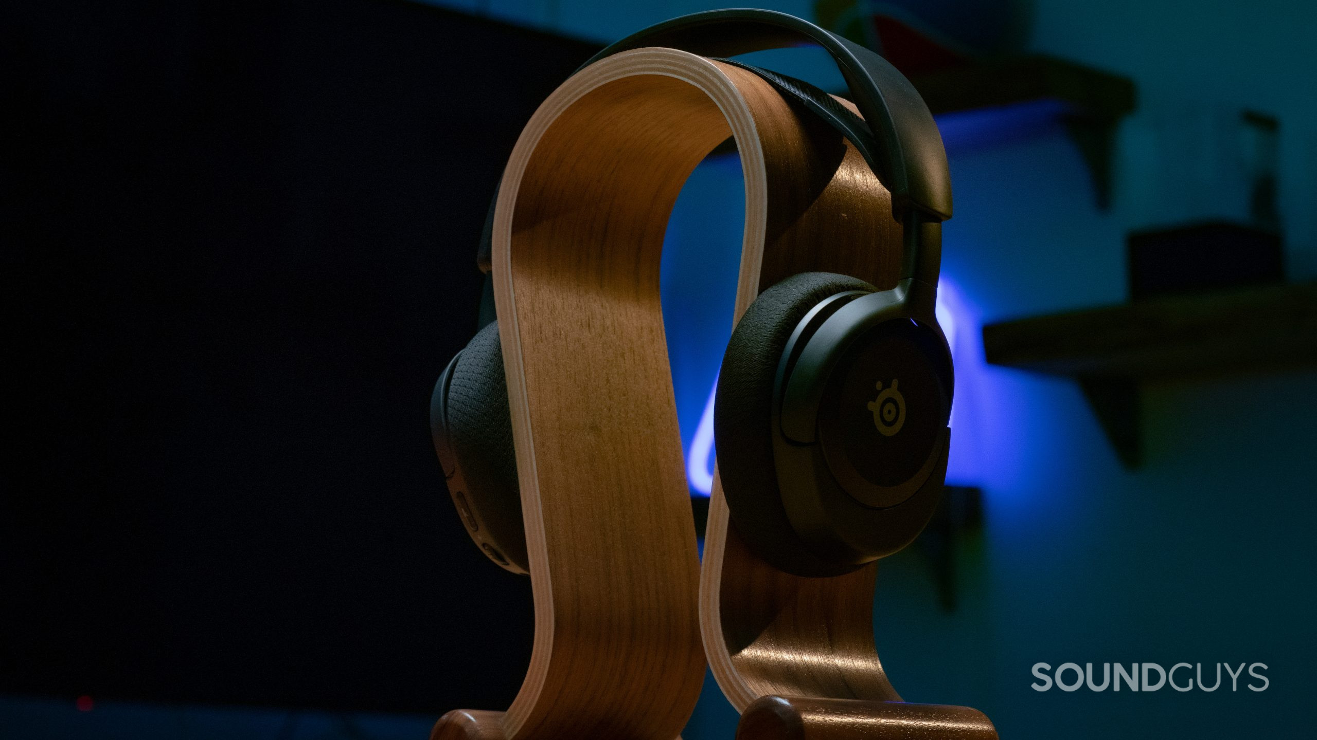The SteelSeries Arctis Nova 1 sitting on a wooden headphone stand.
