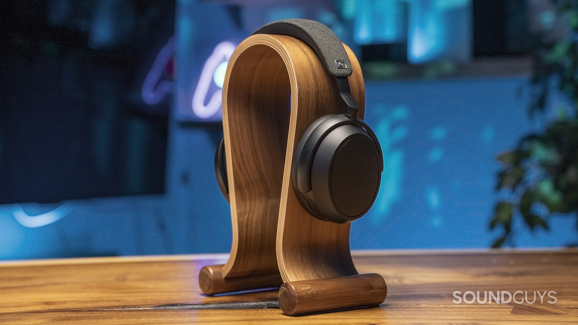 The Sennheiser momentum 4 wireless sits on a headphone stand