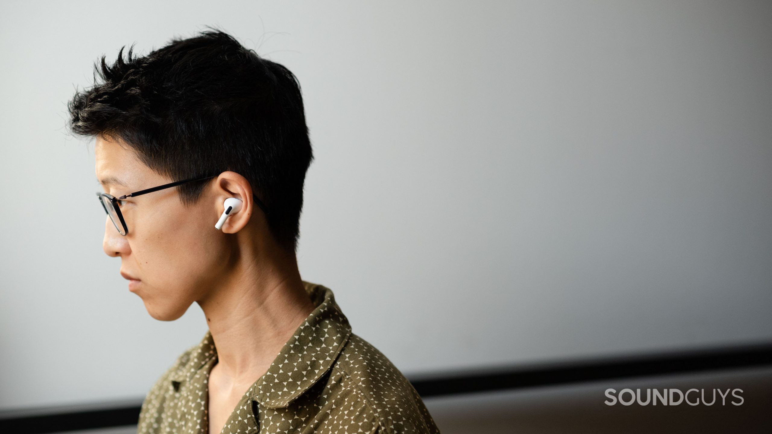 A person wears the Apple AirPods Pro (2nd generation) in profile view.