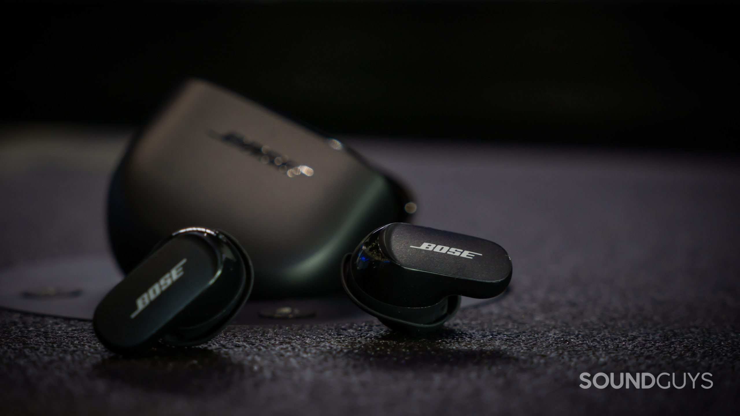 The Bose QuietComfort Earbuds II with the earbuds outside of the angled case.