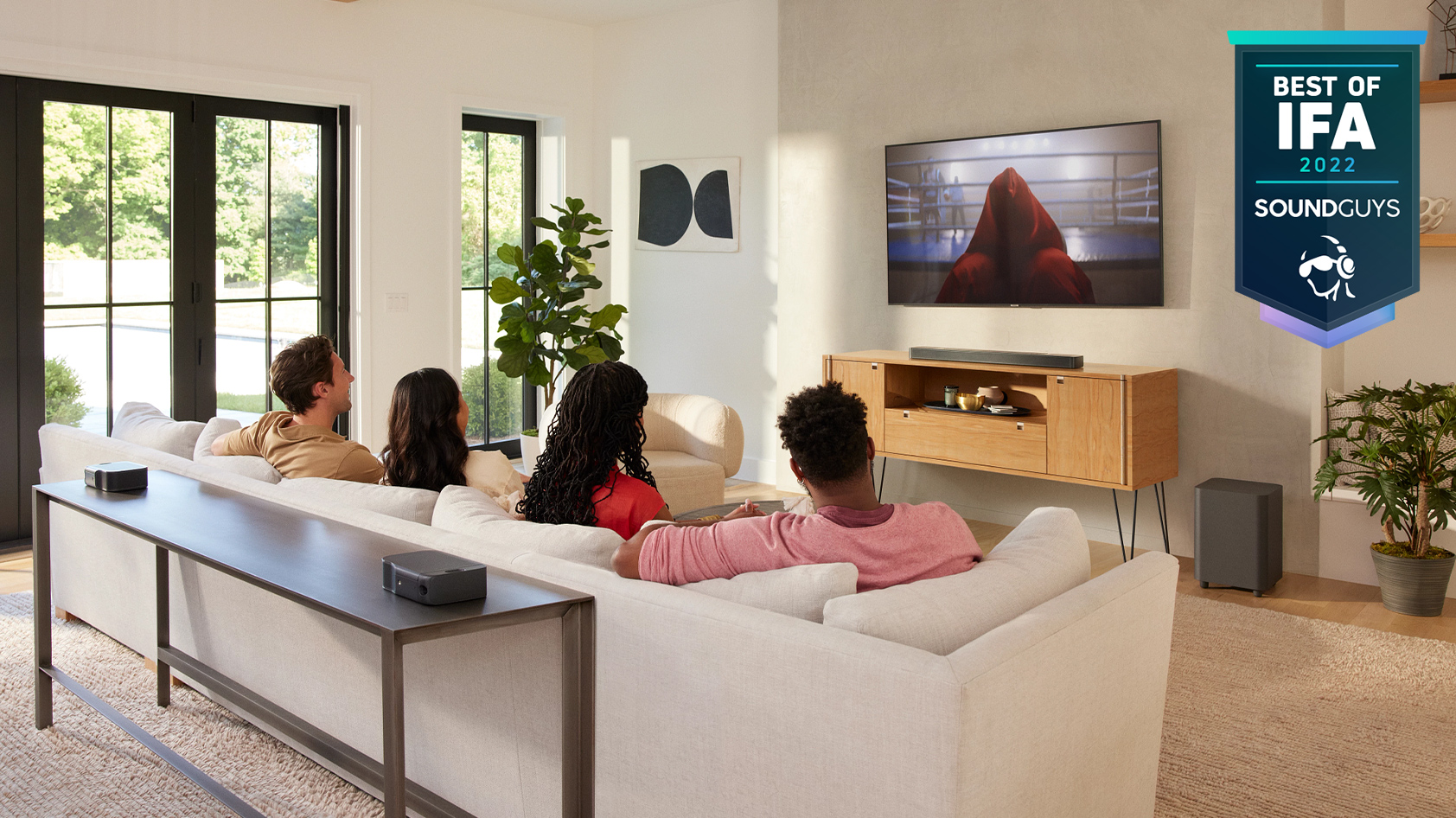 A family sits together to watch a movie with the JBL Bar 1000.