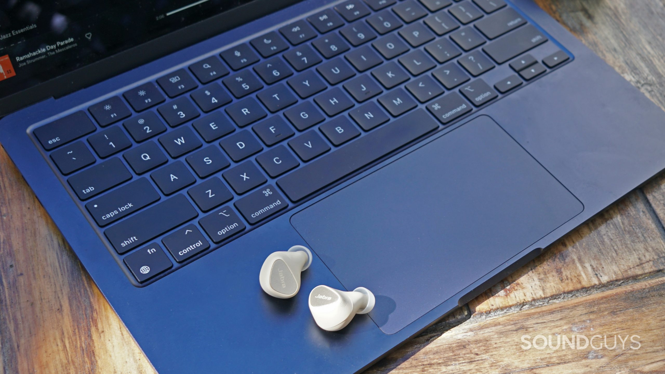 The Jabra Elite 5 true wireless earbuds sit on an Apple MacBook Air.