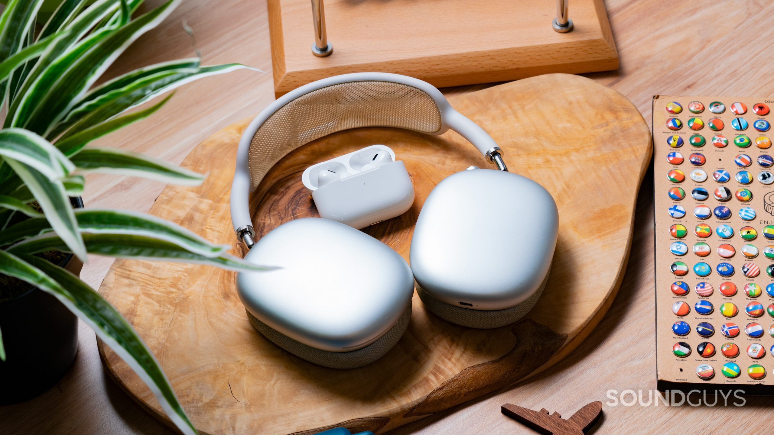 The Apple AirPods Max and Apple AirPods Pro (2nd generation) on a wooden slab next to each other.