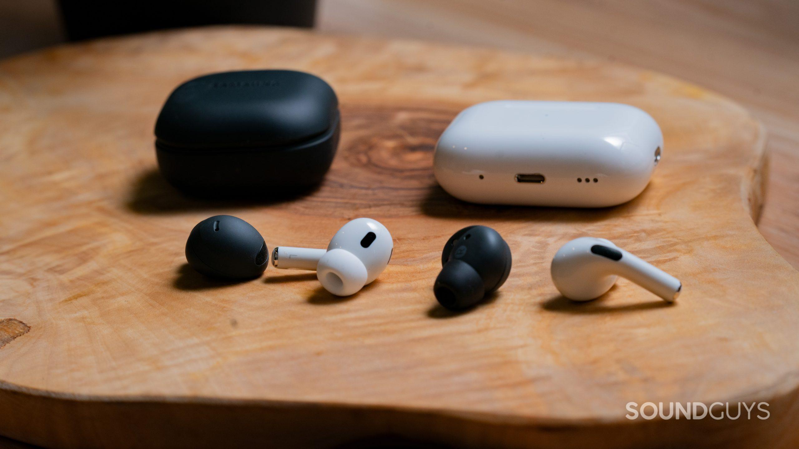 The Samsung Galaxy Buds 2 Pro sits next to the Apple AirPods Pro (2nd generation) with the buds next to each other to show the differences.