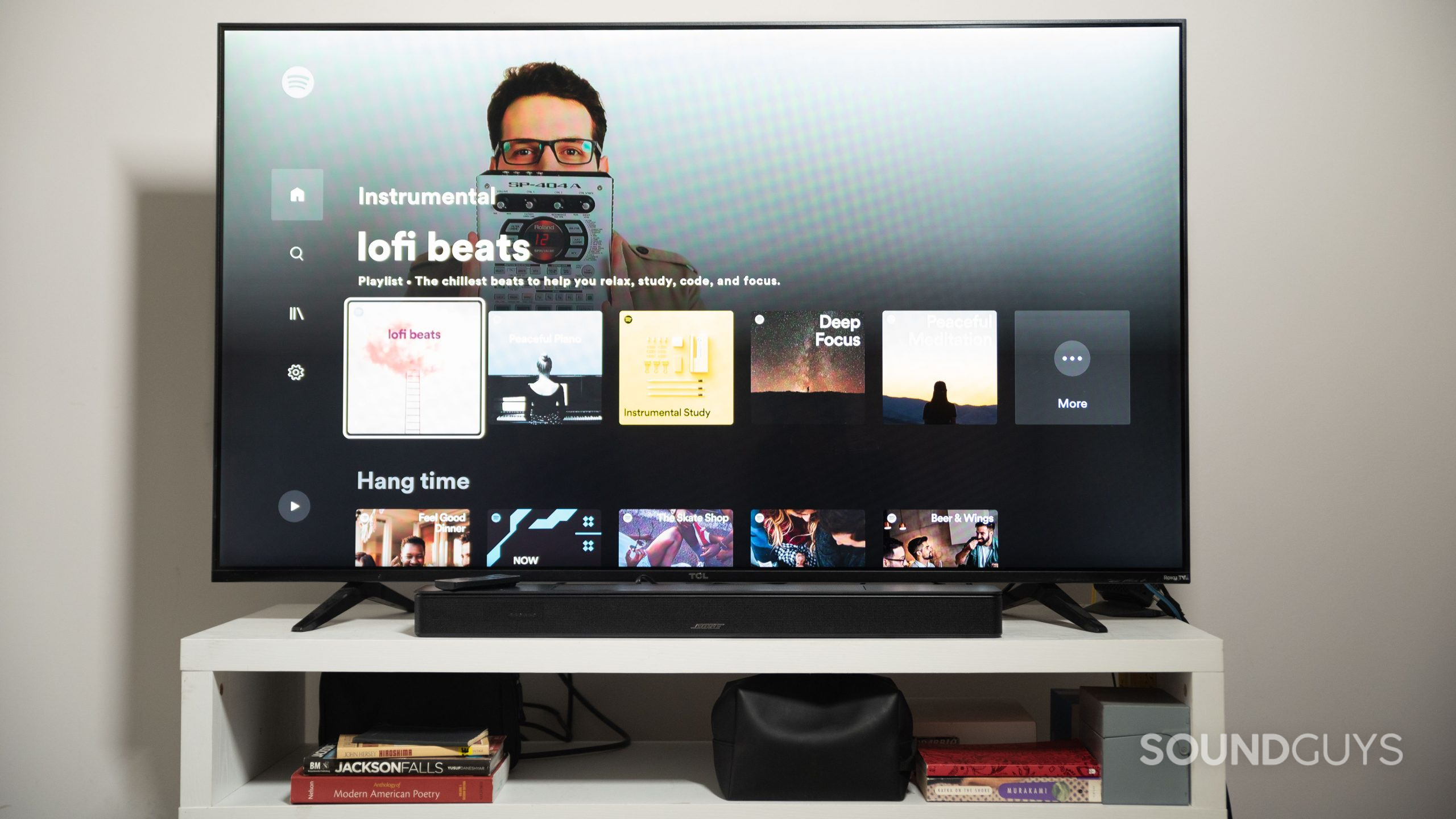 The Bose Smart Soundbar 600 beneath a TCL TV with Spotify pulled up.