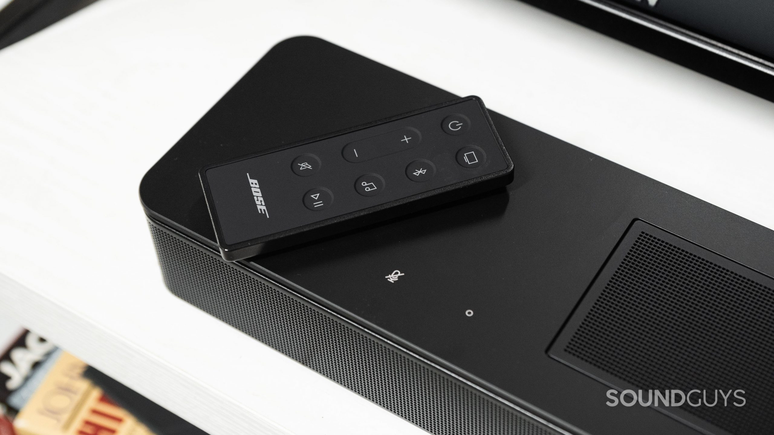 The remote for the Bose Smart Soundbar 600 rests on top of the speaker.