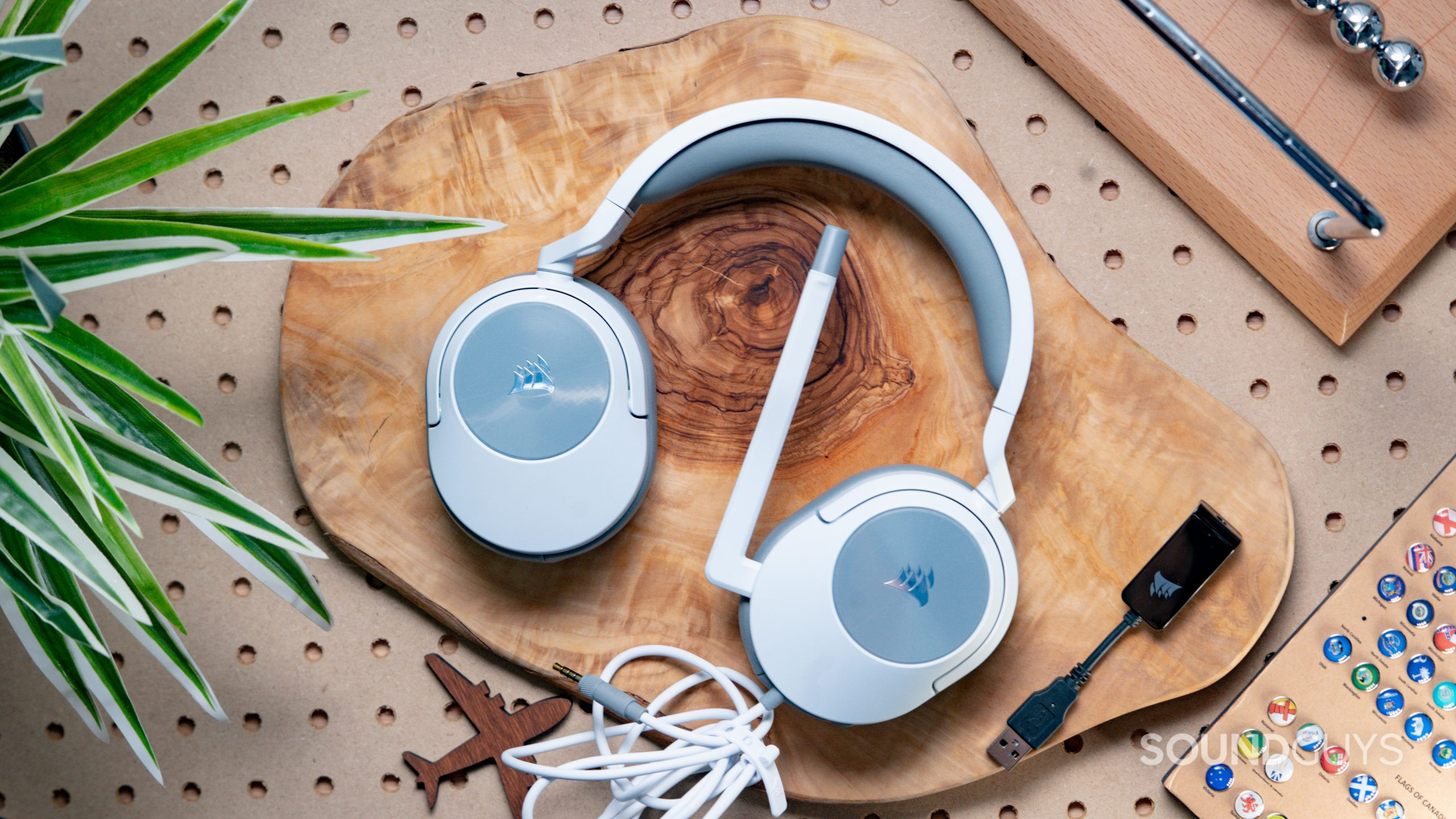 The Corsair HS55 Surround sitting on top of a wooden surface with the ear cups folded flat.